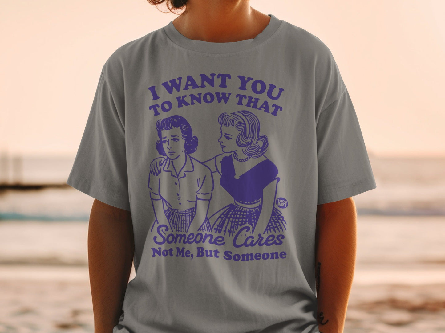T-shirt with purple graphic of two women and text "I want you to know that someone cares, not me, but someone."