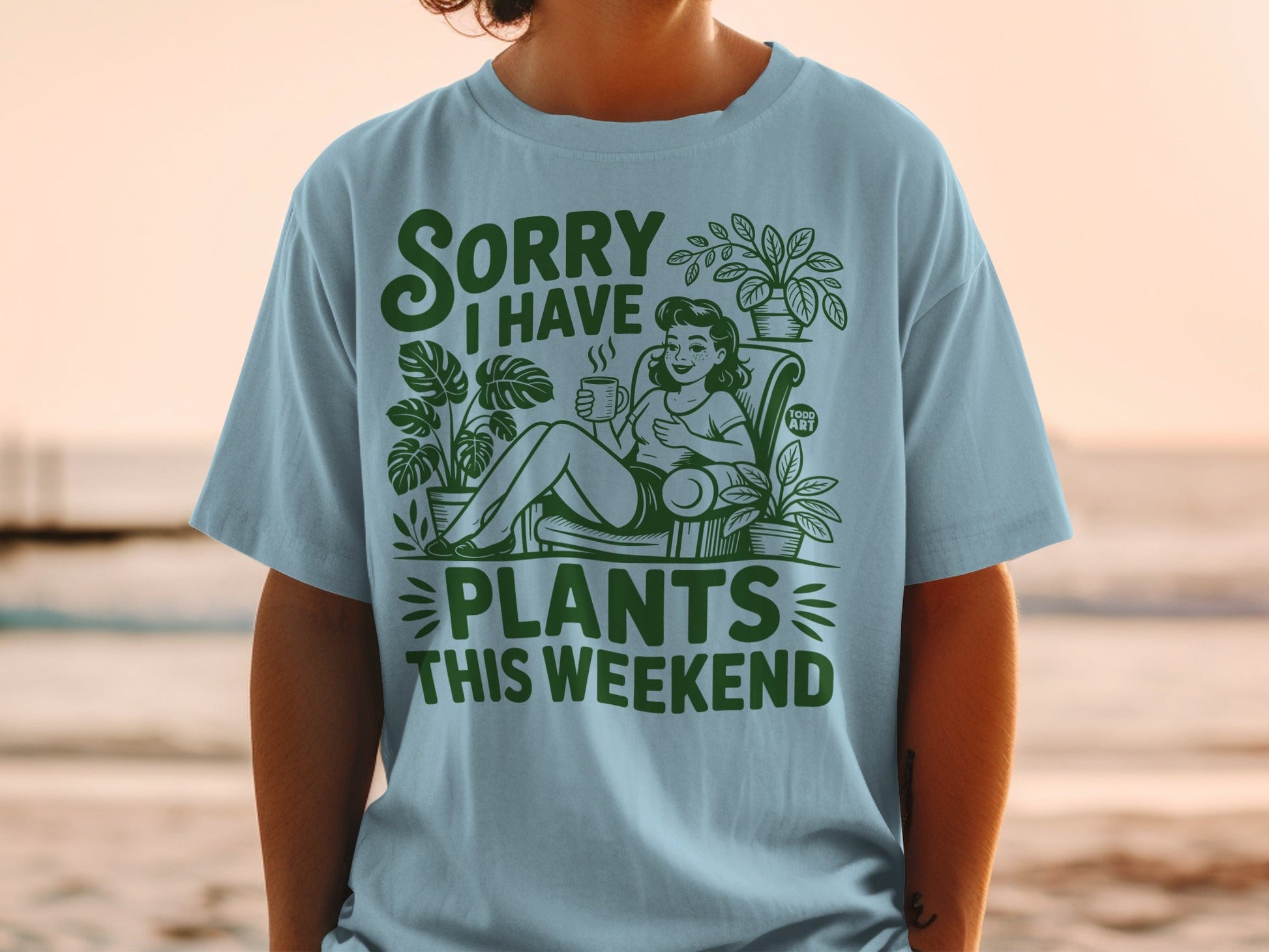 Light blue t-shirt with "Sorry I Have Plants This Weekend" text and illustration.