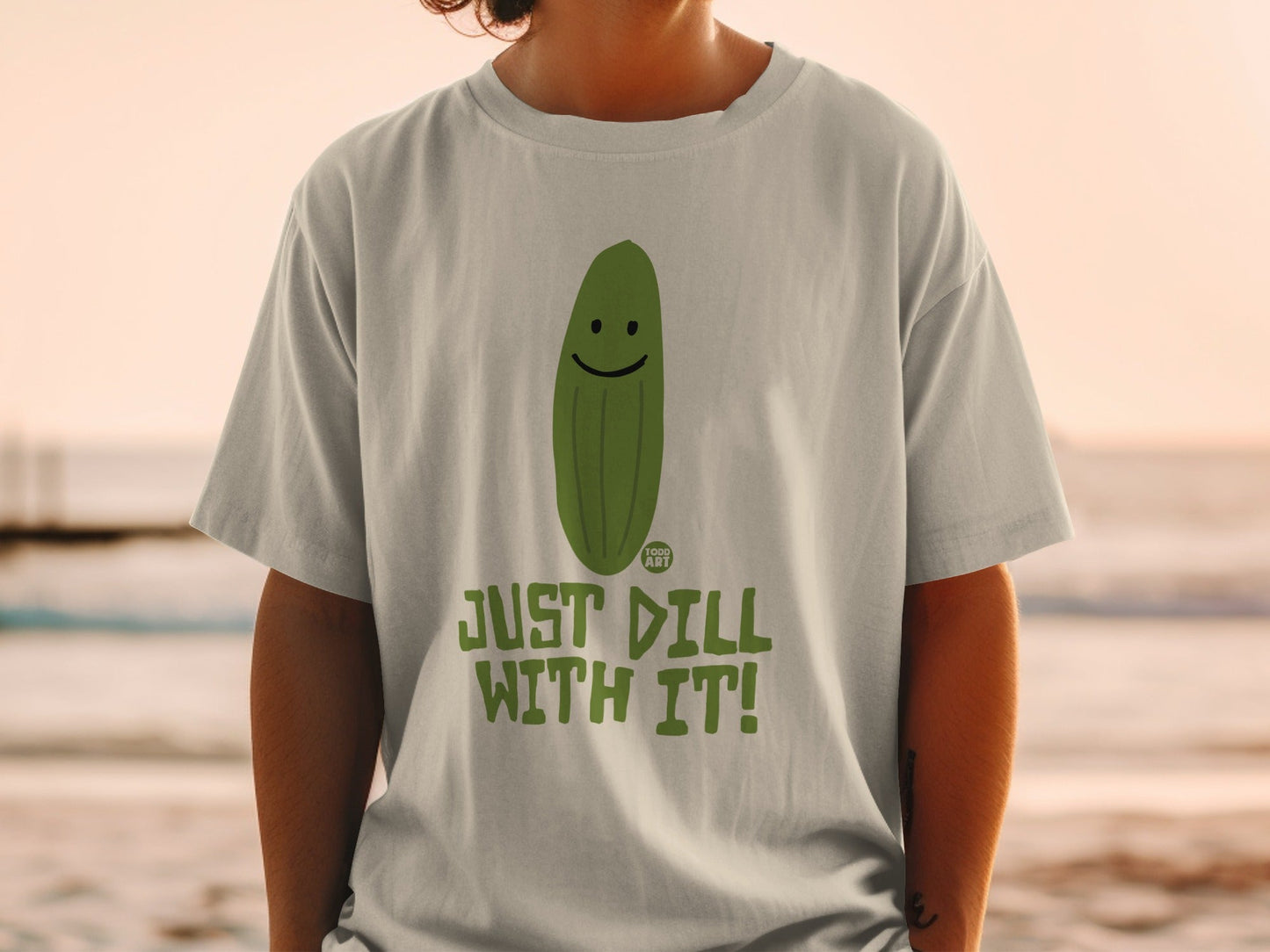 T-shirt with a smiling pickle and "JUST DILL WITH IT!" text.