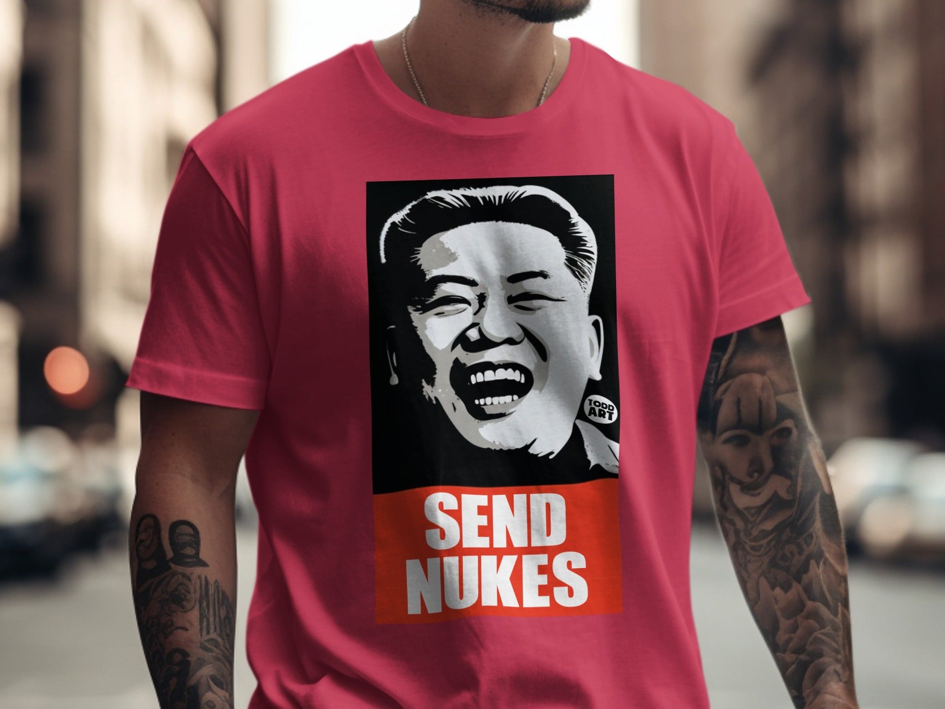 Pink t-shirt with illustration of Kim Jong Un and "SEND NUKES" text.