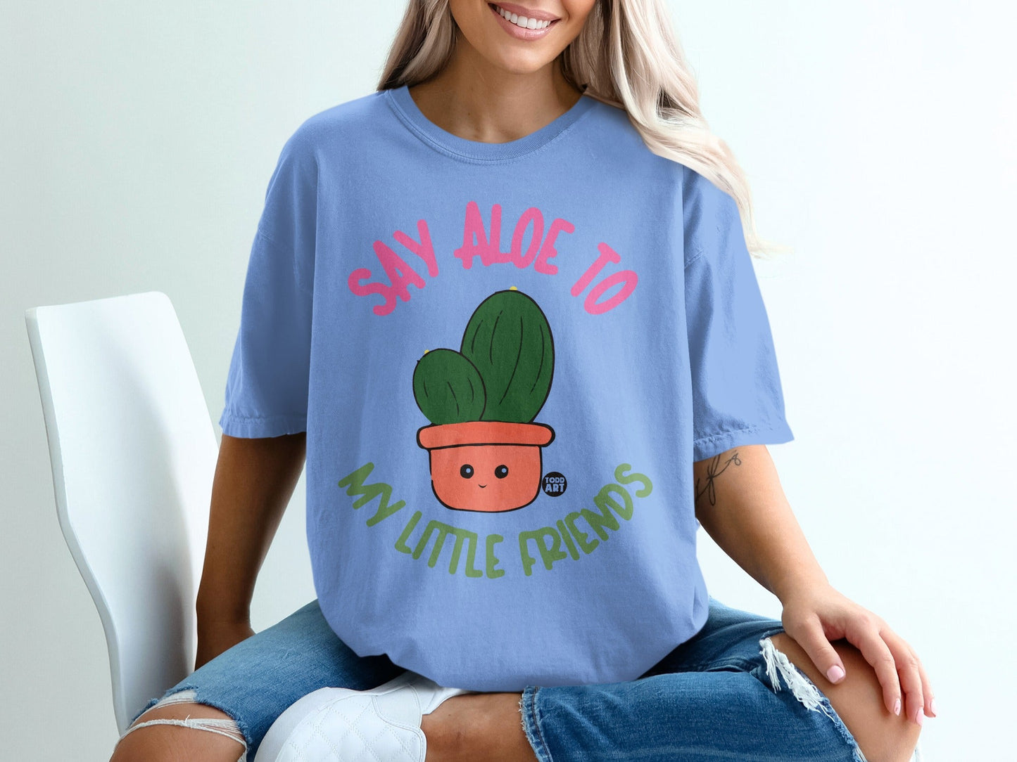 T-shirt with pink text "SAY ALOE TO MY LITTLE FRIENDS" and a smiling cactus.