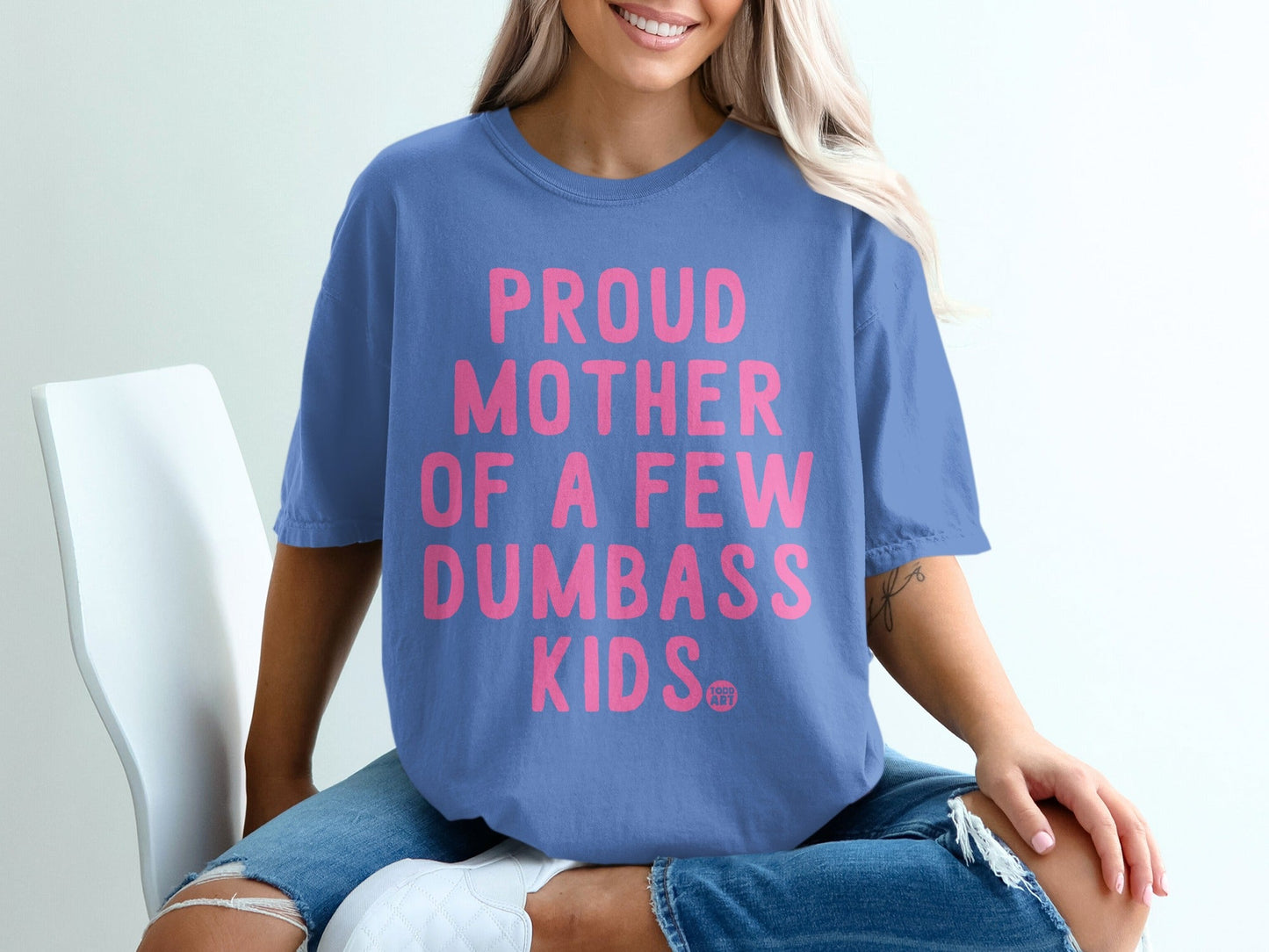 Periwinkle t-shirt with pink text "Proud Mother of a Few Dumbass Kids".