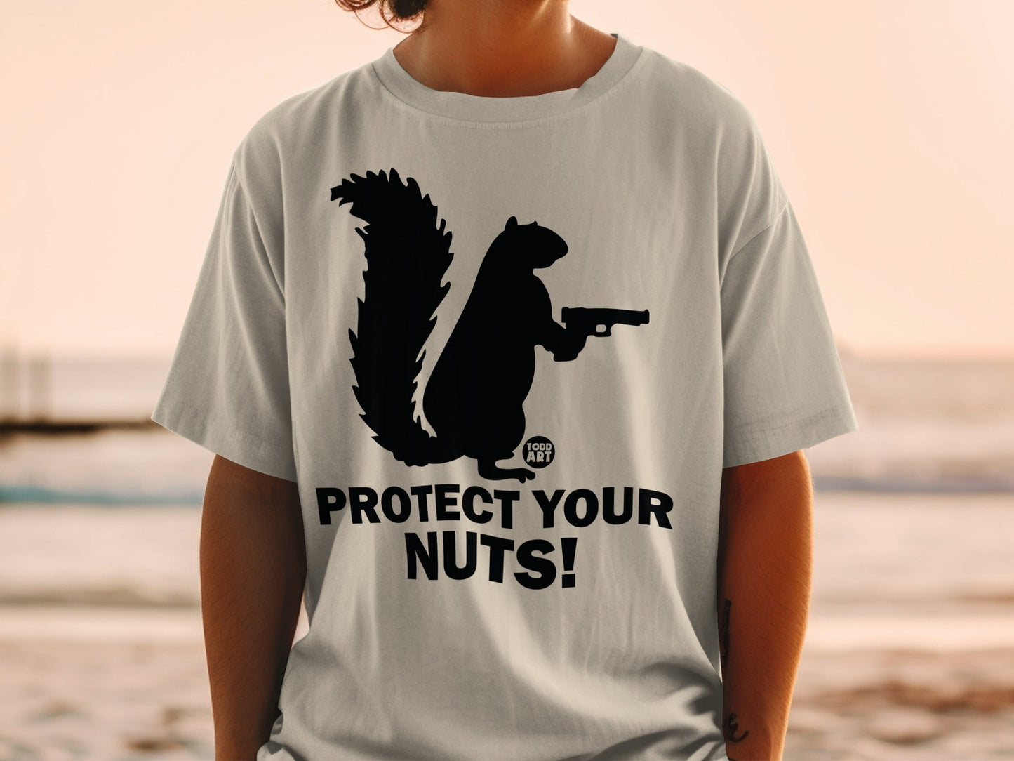 Light grey t-shirt with black squirrel holding gun and "PROTECT YOUR NUTS!" text.