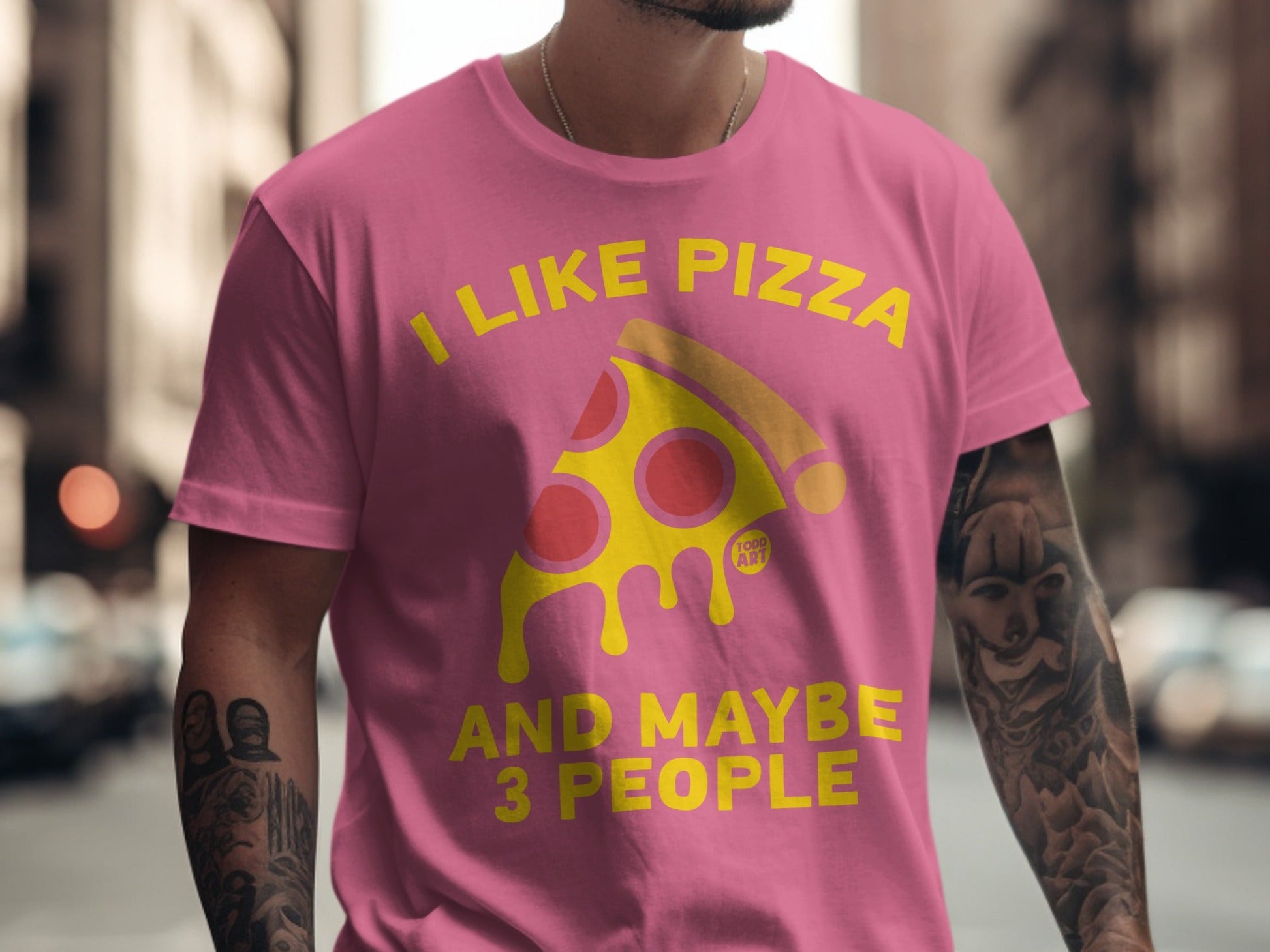 Pink t-shirt with yellow text and a pizza graphic: "I LIKE PIZZA AND MAYBE 3 PEOPLE".