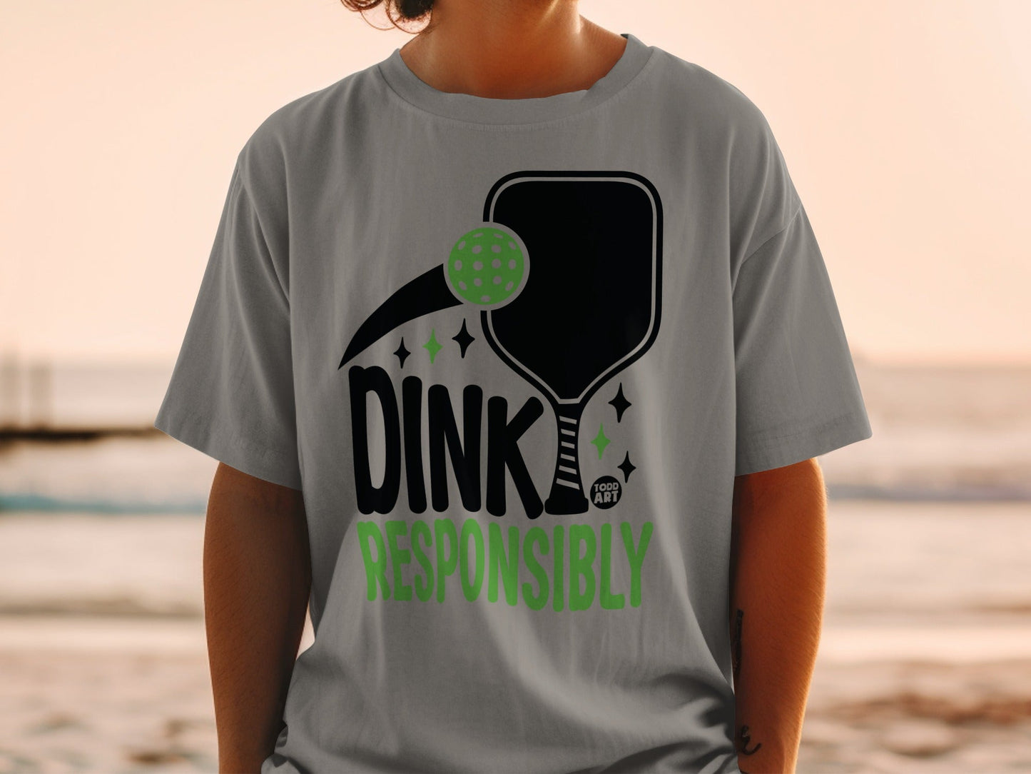 Gray t-shirt with pickleball paddle, pickleball, and "Dink Responsibly" text.