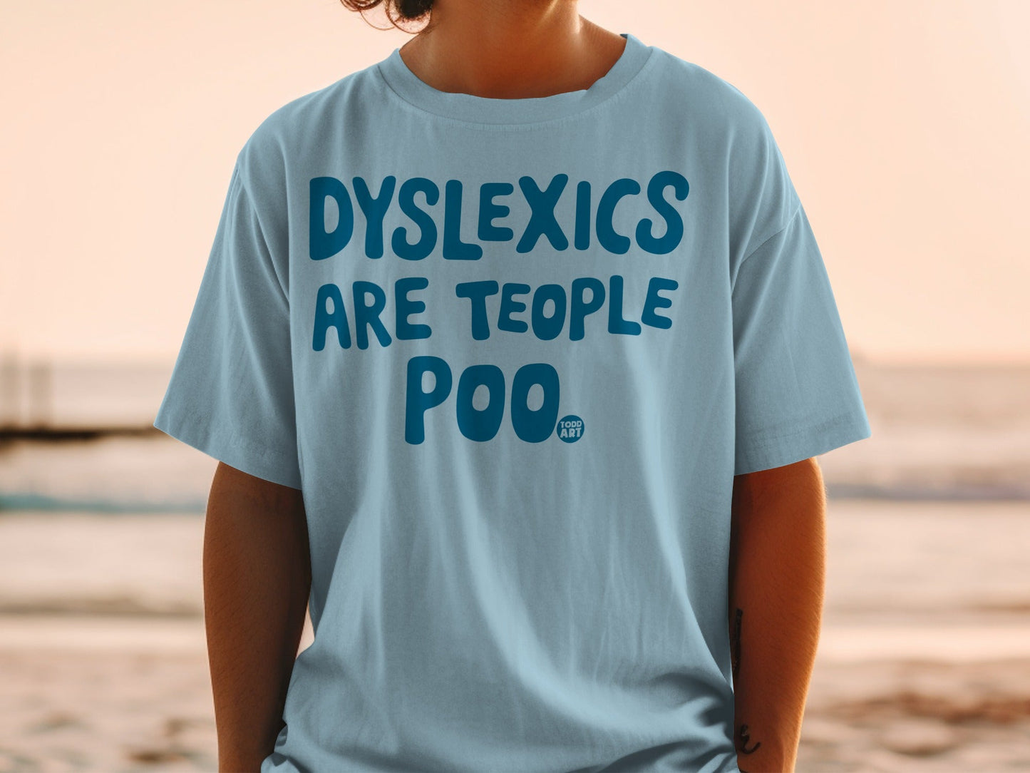 Blue t-shirt with "DYSLEXICS ARE TEOPLE POO" and a small logo.