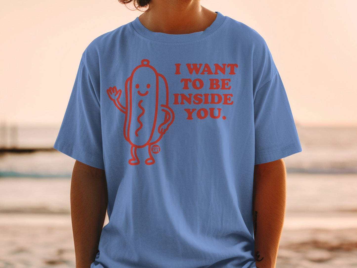 Blue t-shirt with a cartoon hot dog and text "I WANT TO BE INSIDE YOU."