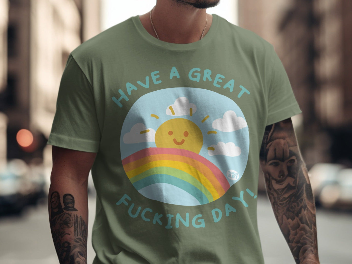Green t-shirt with "Have a great fucking day!" text, sun, and rainbow.