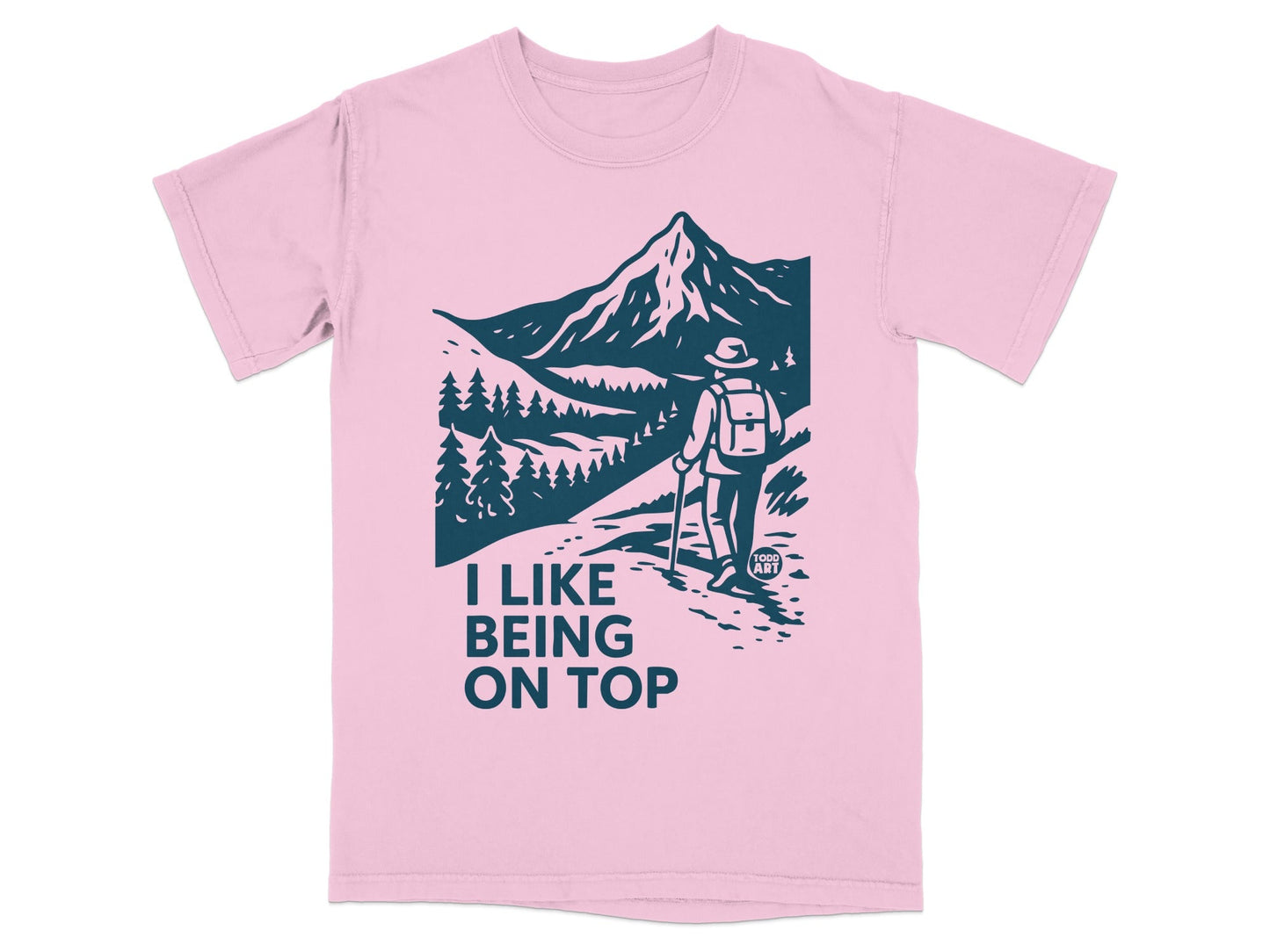 Pink t-shirt with a hiker and mountain graphic, "I Like Being On Top" text.