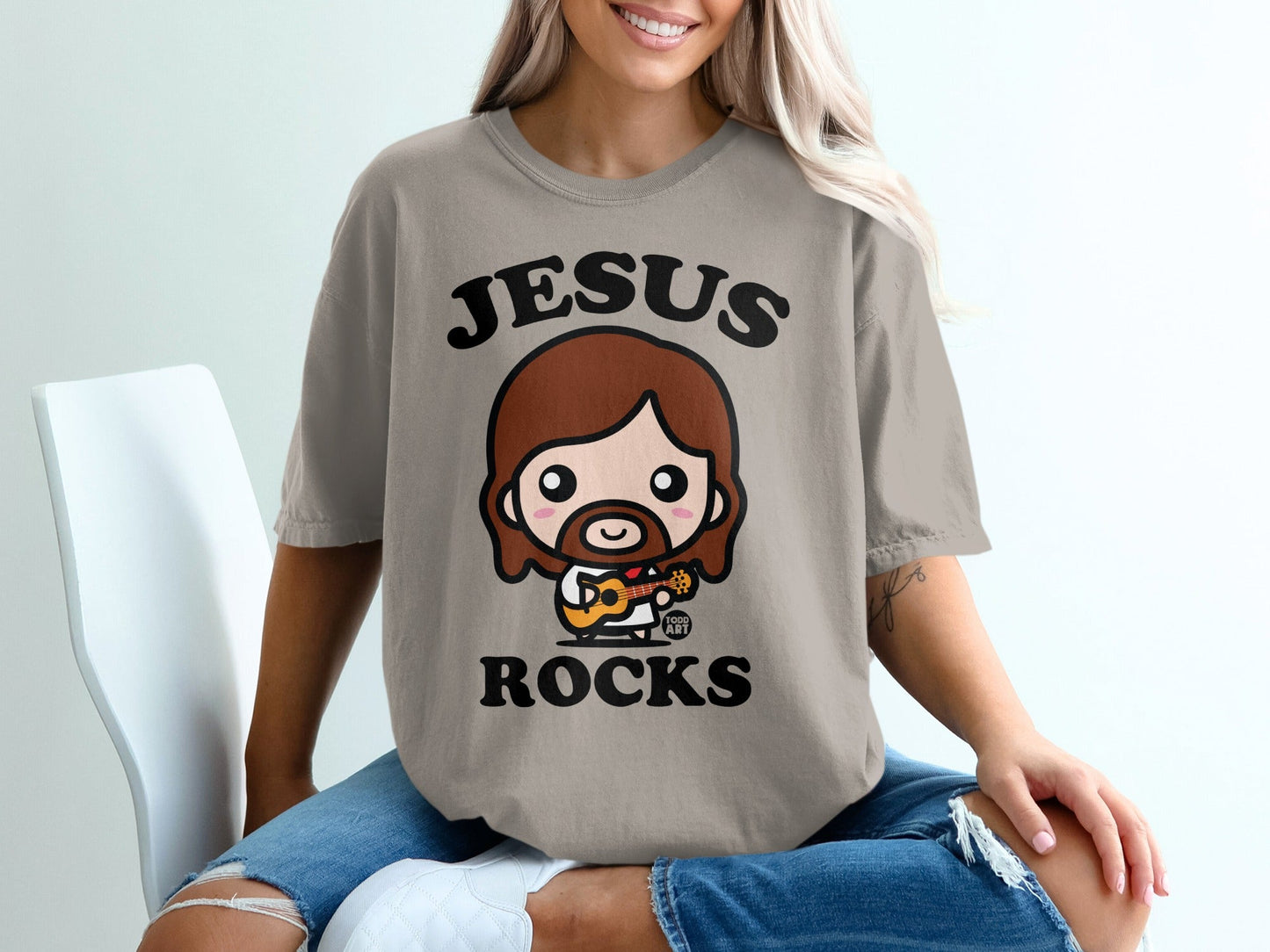 T-shirt with cartoon Jesus playing guitar, text "JESUS ROCKS".