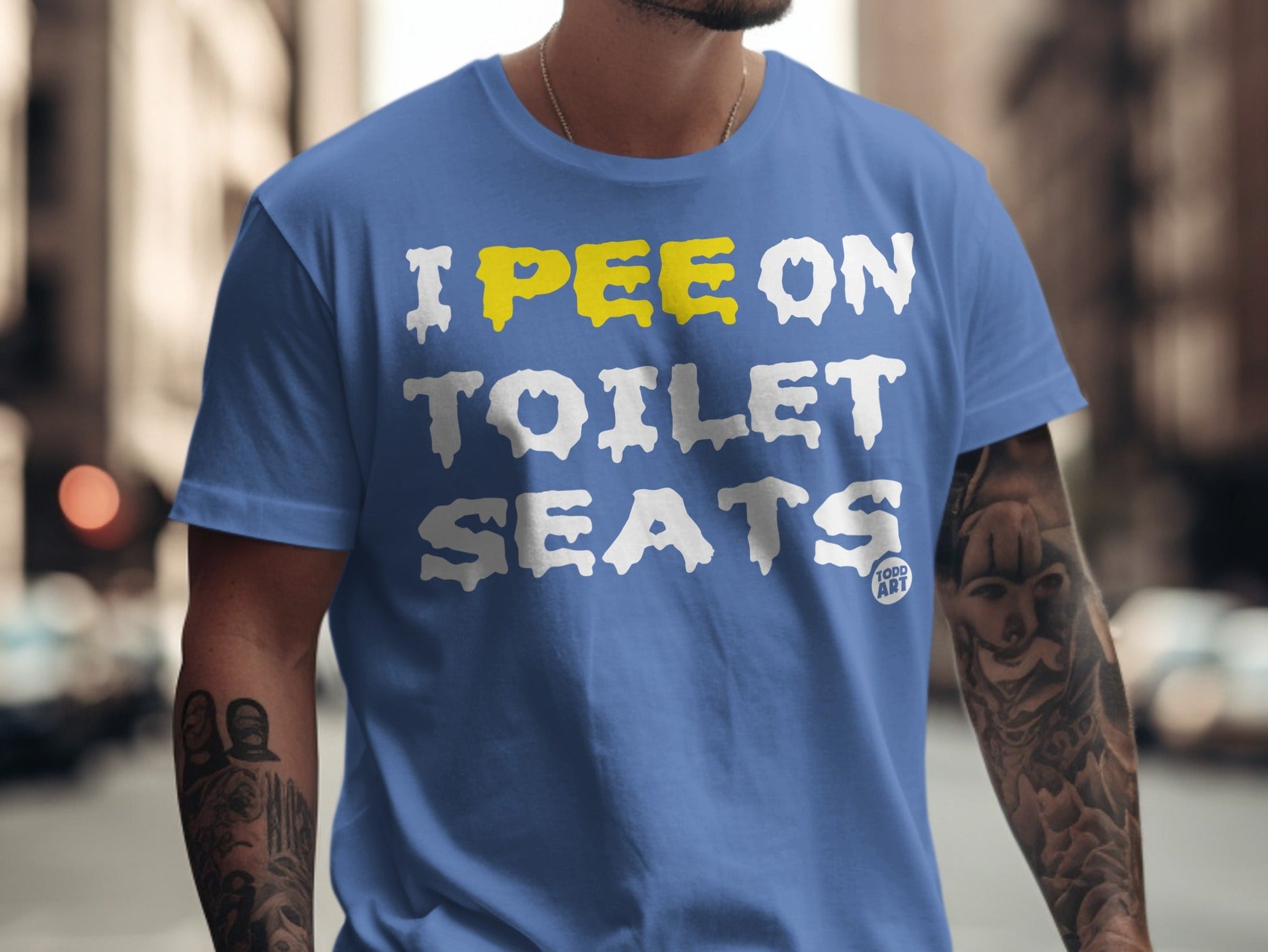 Blue t-shirt with yellow and white text "I pee on toilet seats".