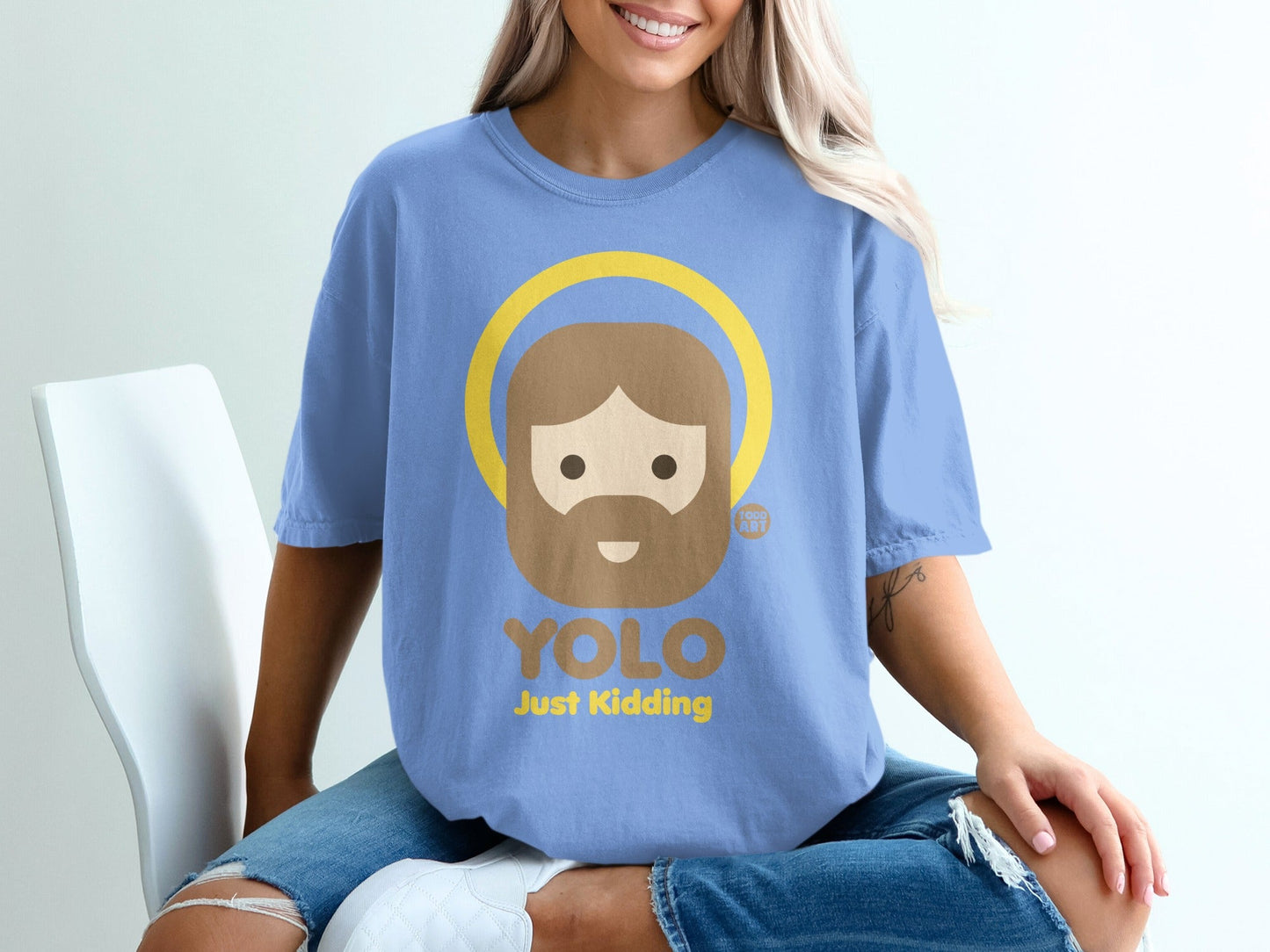 Blue t-shirt with a cartoon Jesus graphic saying "YOLO JUST KIDDING".