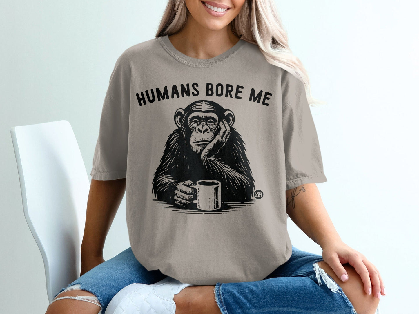 T-shirt with chimpanzee holding coffee cup and text "HUMANS BORE ME".