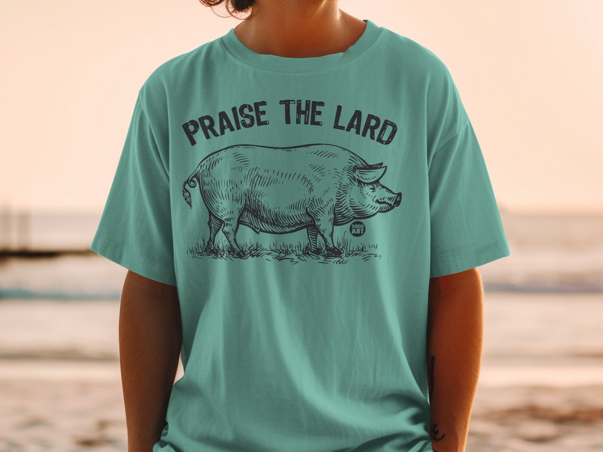 T-shirt with a sketch of a pig and text "PRAISE THE LARD".