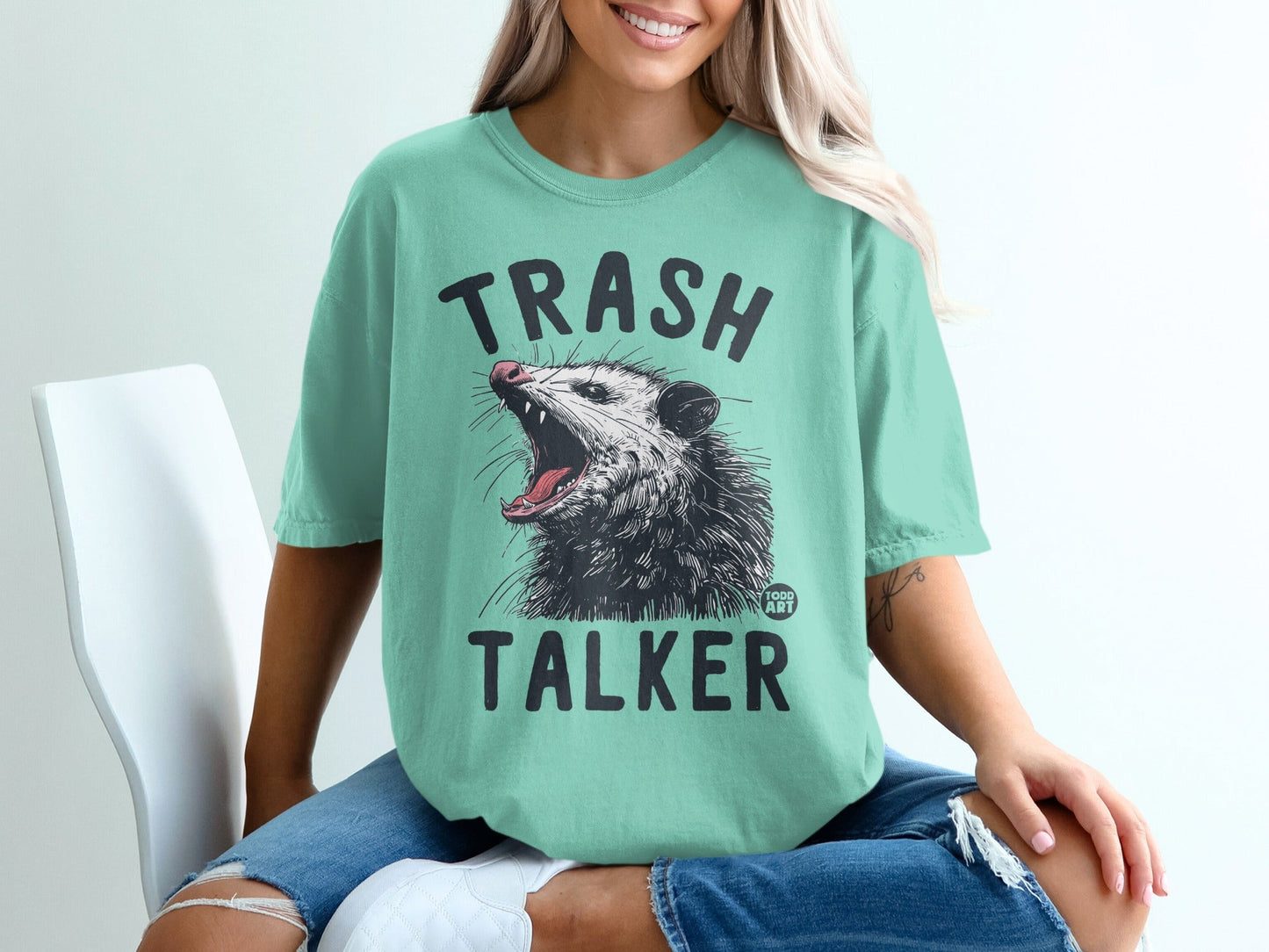 Green t-shirt with "TRASH TALKER" and an opossum graphic.