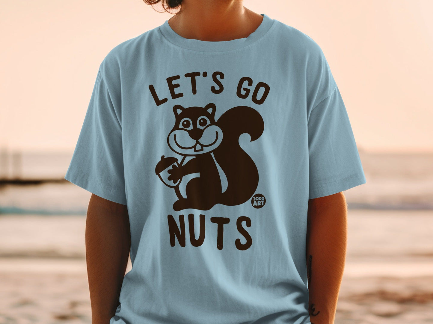 Light blue t-shirt with "LET'S GO NUTS" and a cartoon squirrel holding an acorn.
