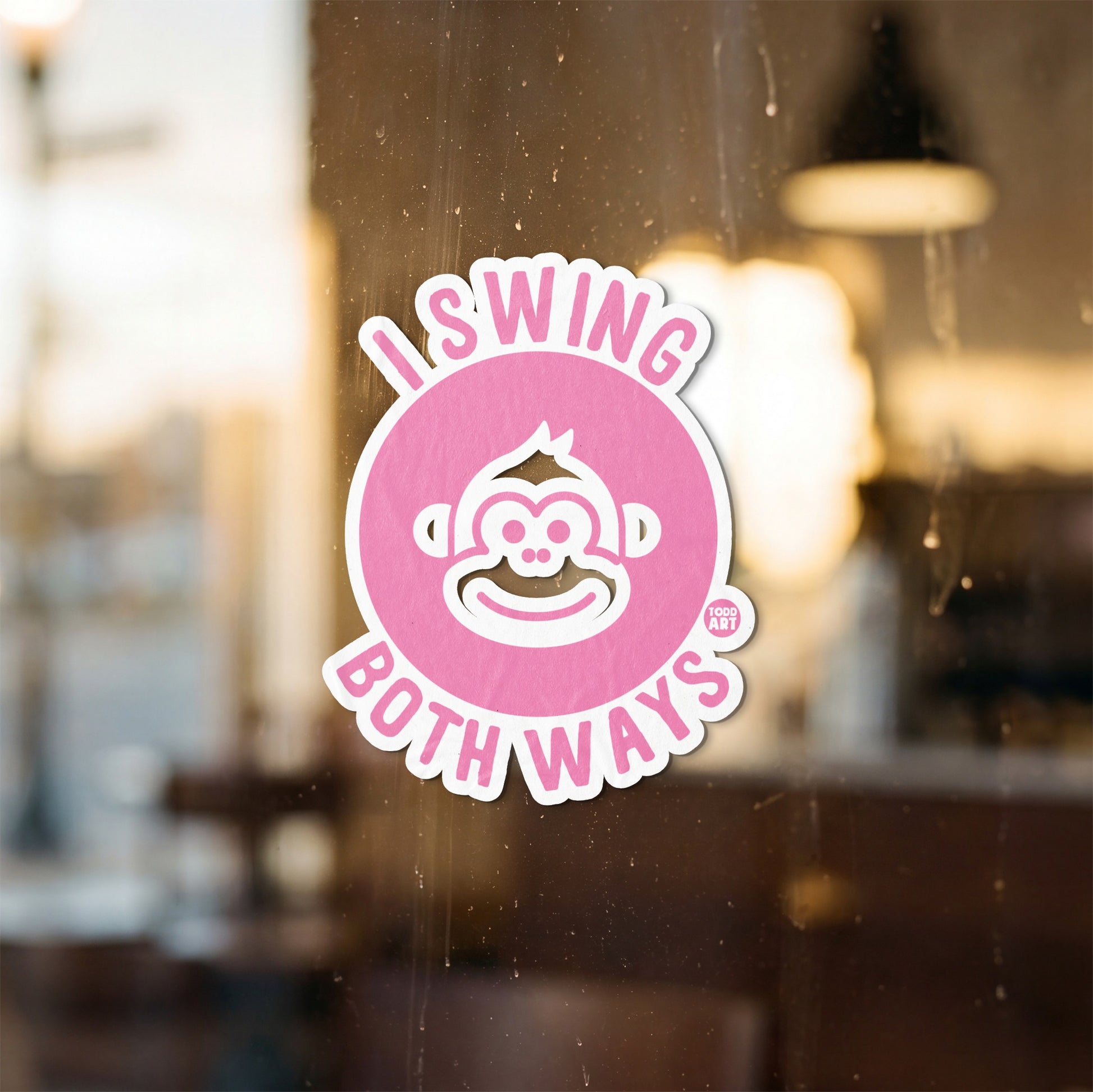 Pink sticker with a monkey face and the text "I SWING BOTH WAYS".