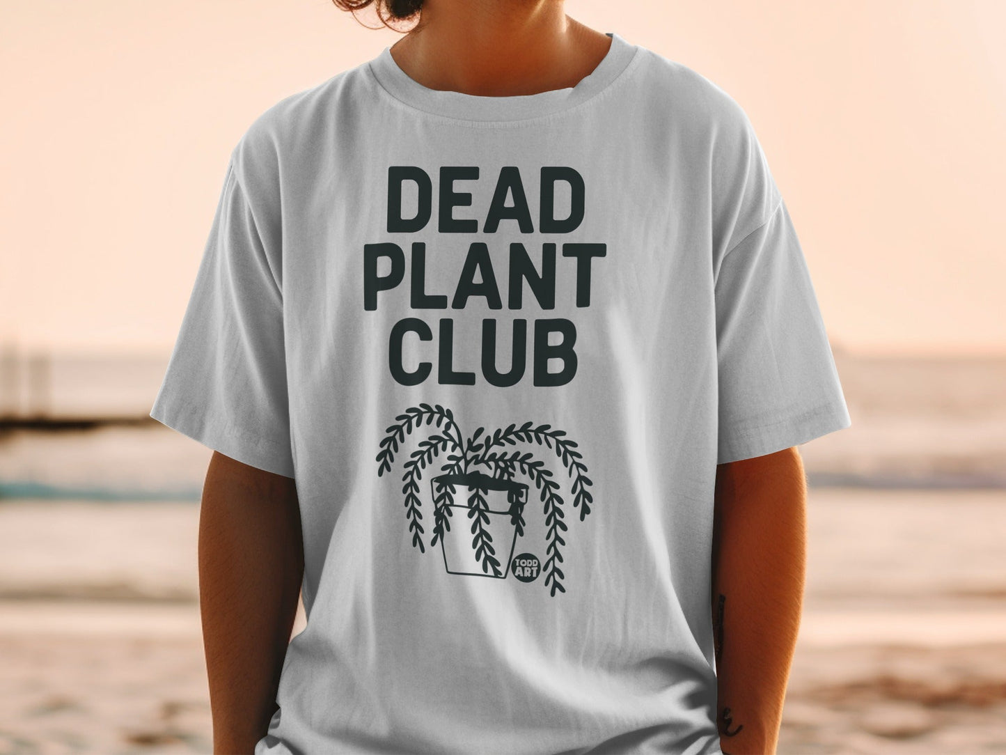 White t-shirt with "DEAD PLANT CLUB" and plant graphic.