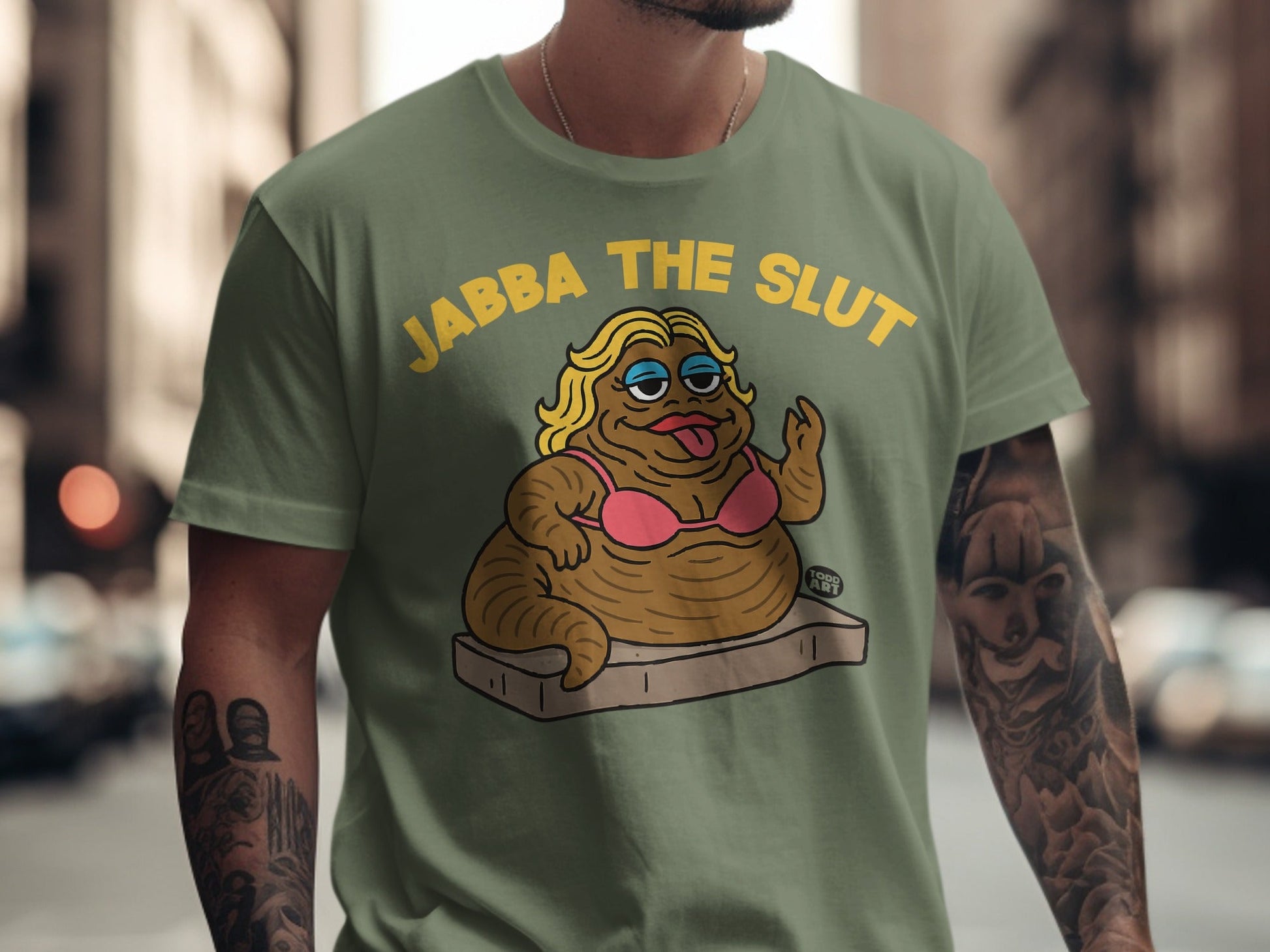 Olive green t-shirt with cartoon Jabba the Hutt in a pink bikini.