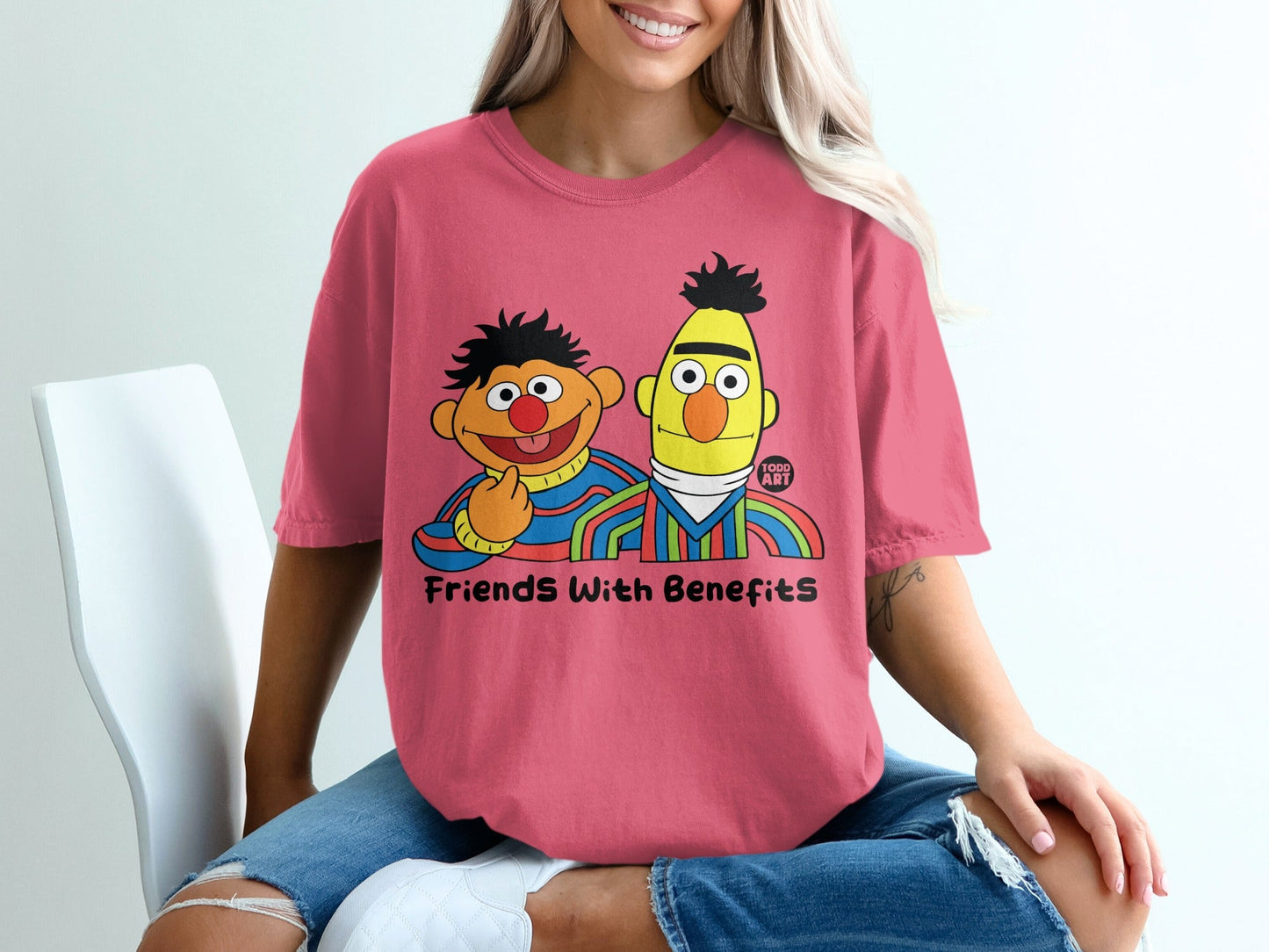 Pink t-shirt featuring Bert and Ernie with "Friends With Benefits" text.