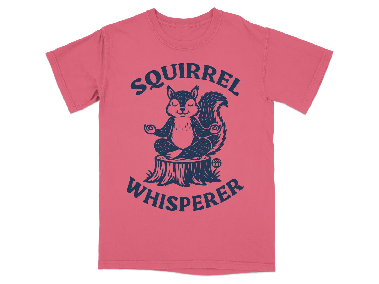Pink t-shirt with a meditating squirrel on a tree stump and "Squirrel Whisperer" text.