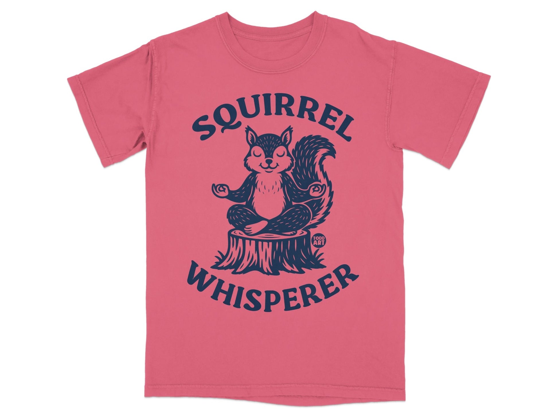 Pink t-shirt with a meditating squirrel on a tree stump and "Squirrel Whisperer" text.