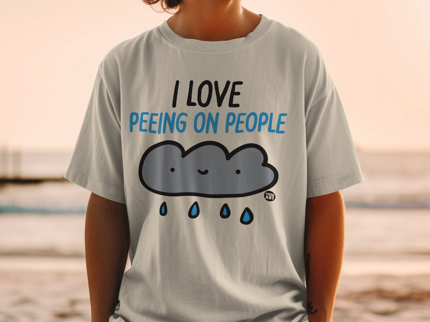 Light grey t-shirt with a cartoon cloud saying "I love peeing on people."