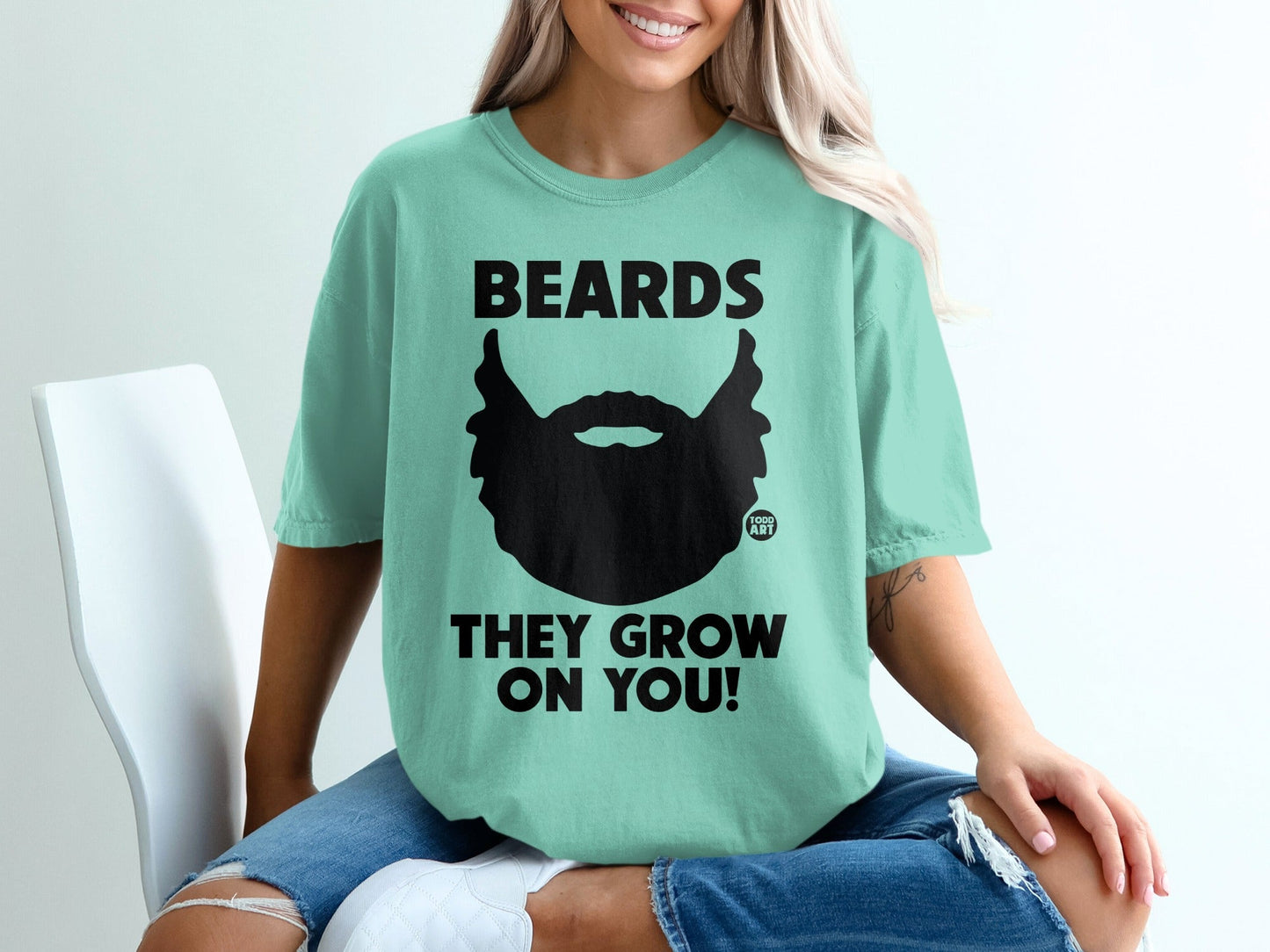 Teal t-shirt with black graphic and text: "BEARDS THEY GROW ON YOU!"