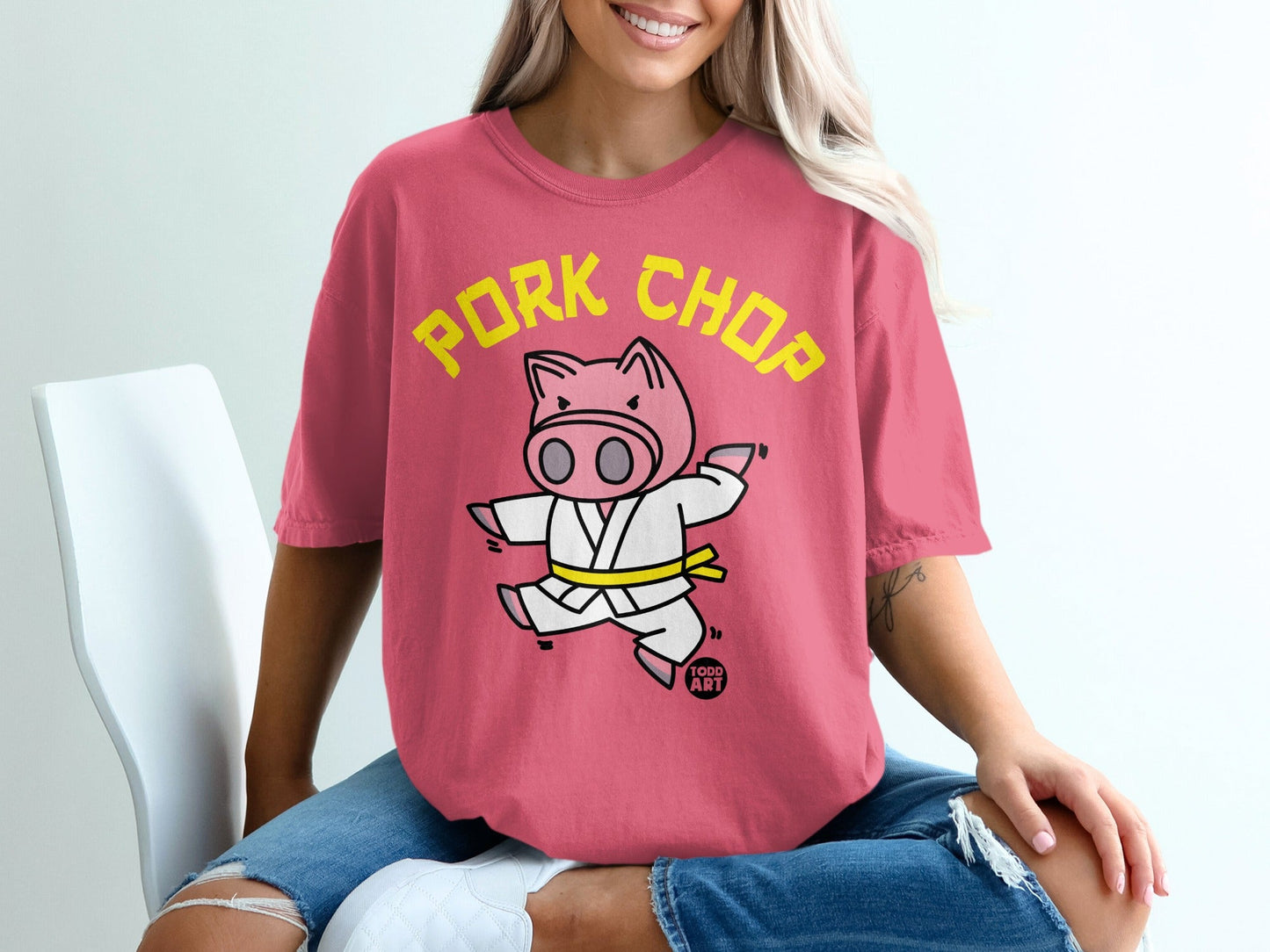 Pink t-shirt with cartoon pig wearing a karate gi, text "PORK CHOP".