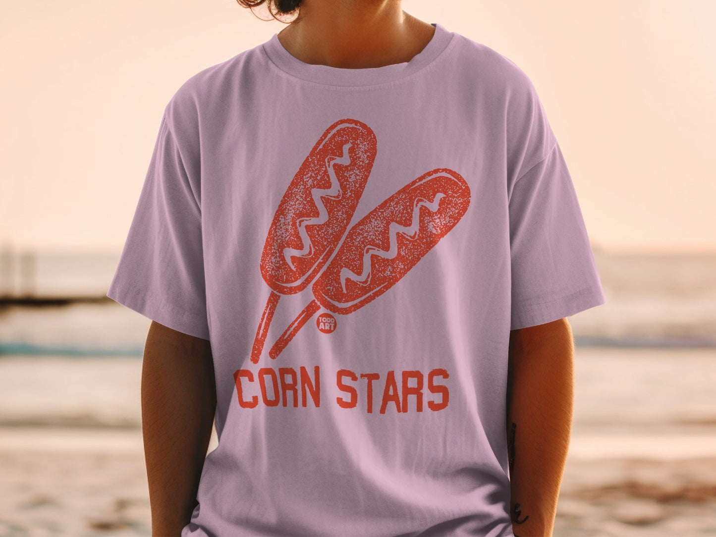Light pink t-shirt with two corn dogs and "CORN STARS" text.