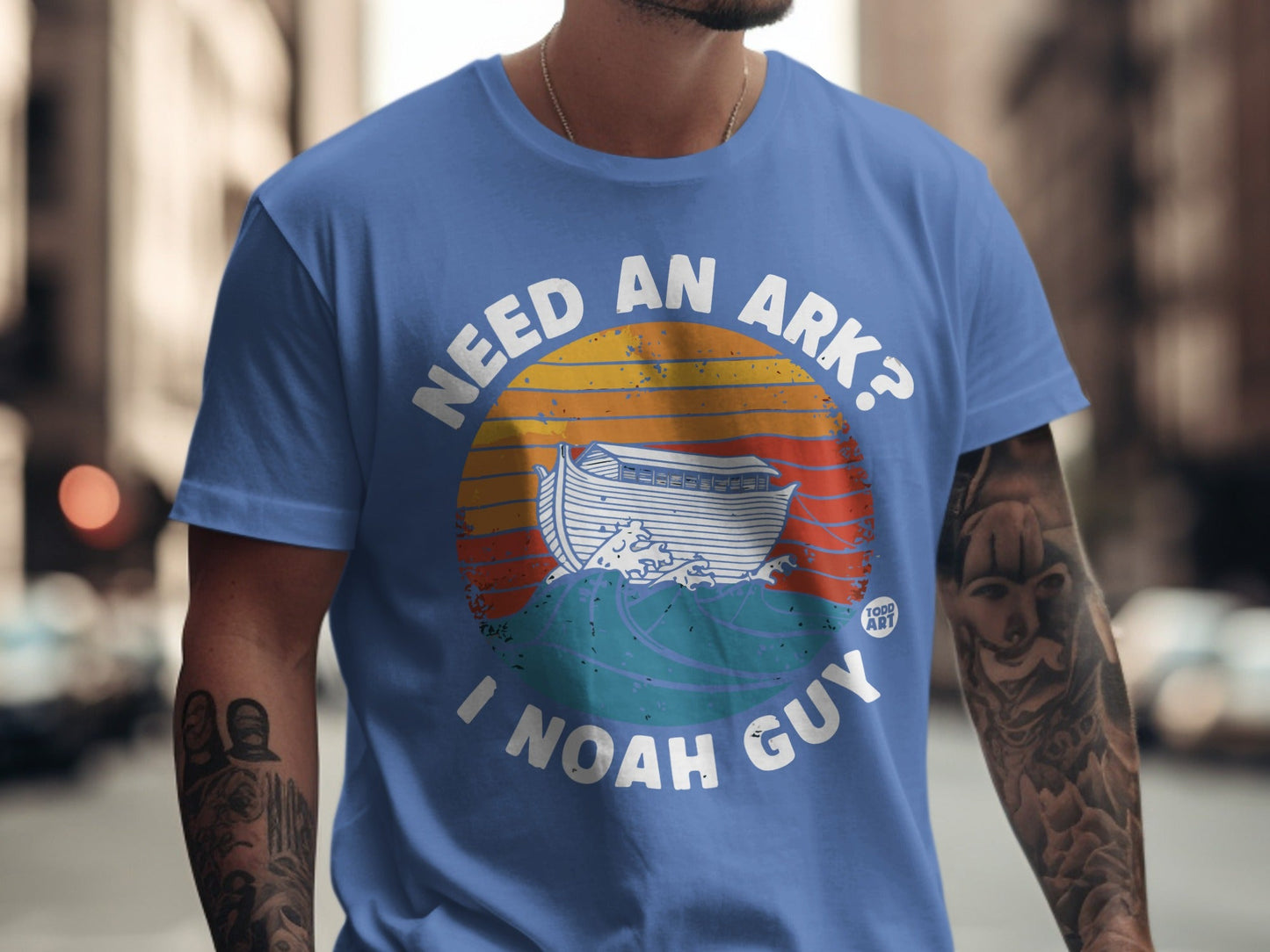 Blue t-shirt with "Need an Ark?" and Noah's Ark illustration.