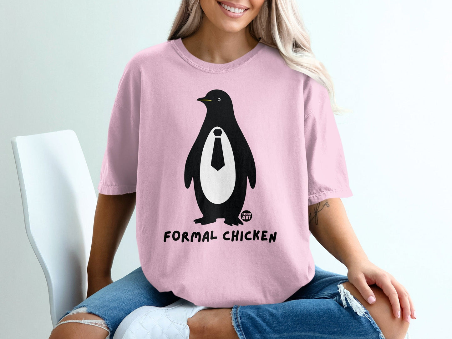 Pink t-shirt with a black and white penguin wearing a tie and text "FORMAL CHICKEN".
