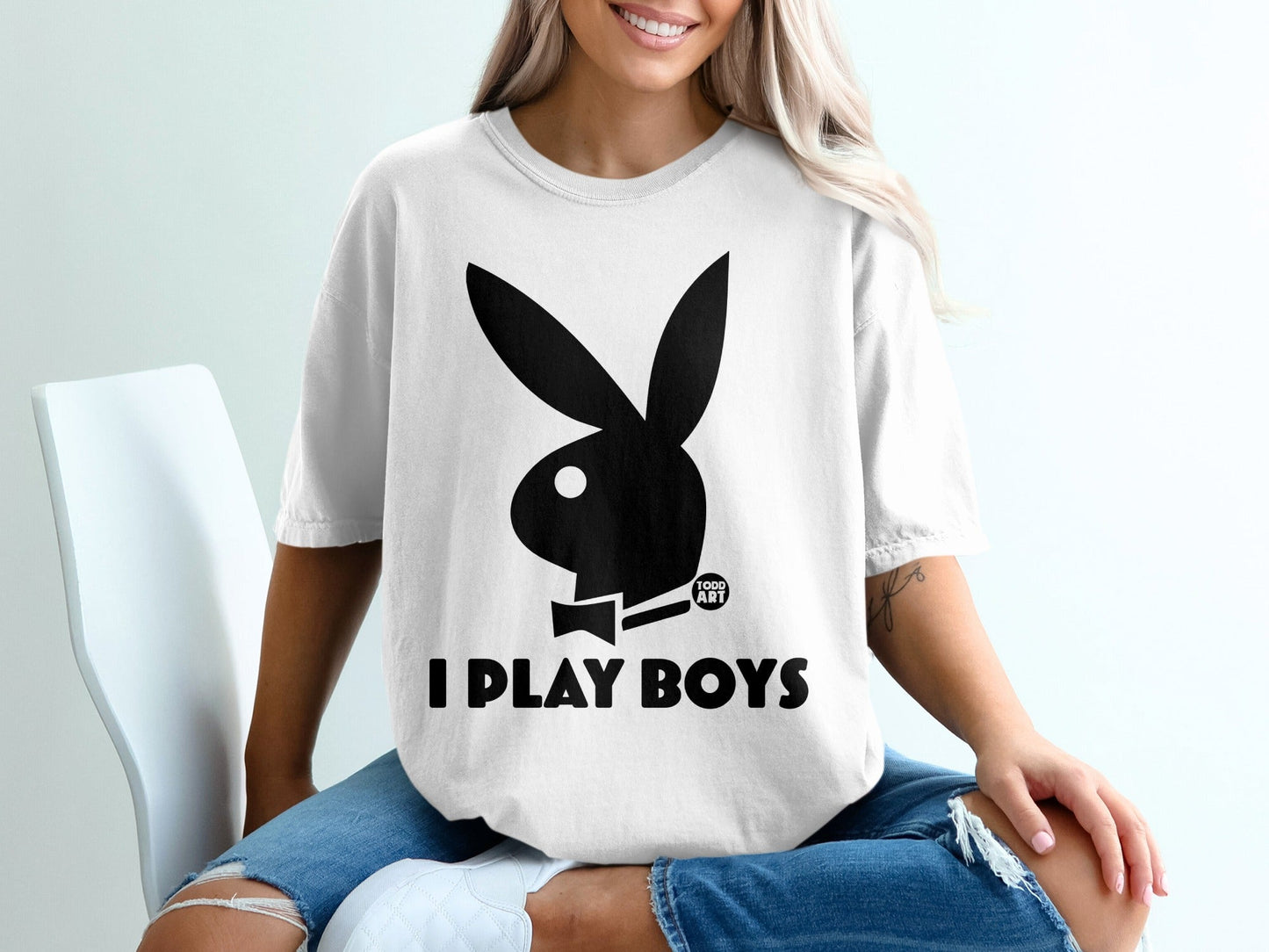 Black Playboy bunny logo and text "I PLAY BOYS" on a white t-shirt.