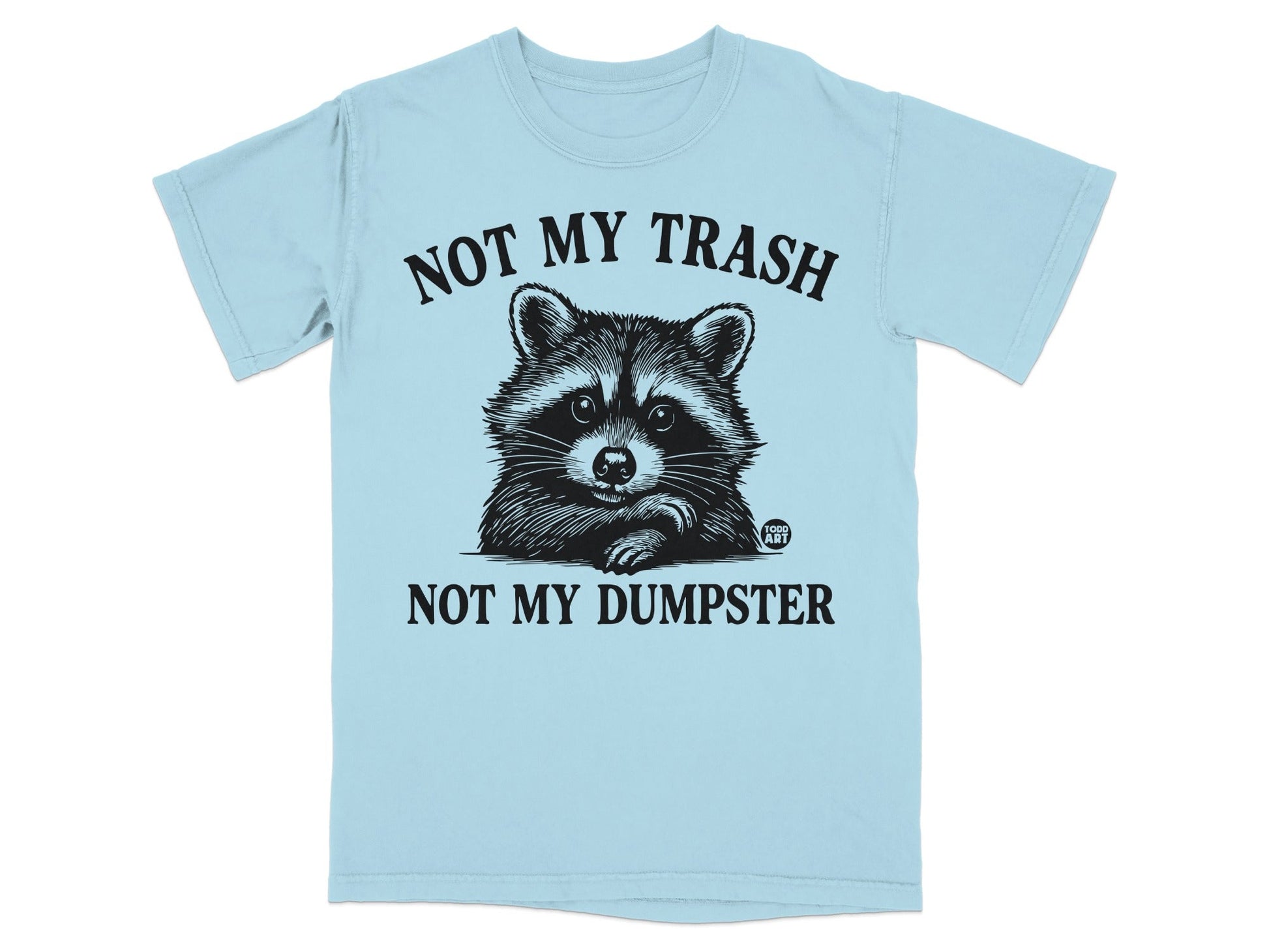Light blue t-shirt with raccoon graphic and text: "NOT MY TRASH NOT MY DUMPSTER".
