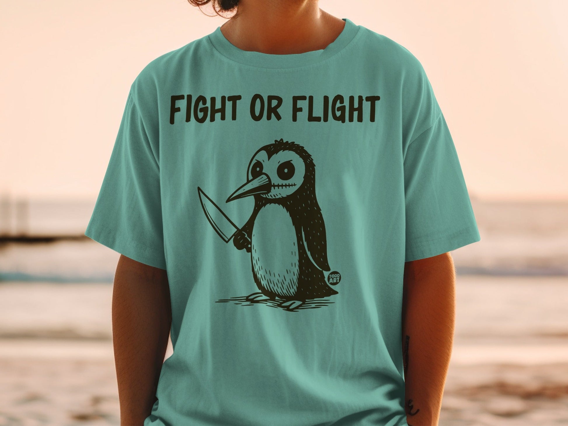 T-shirt with a cartoon penguin holding a knife and the text "FIGHT OR FLIGHT".