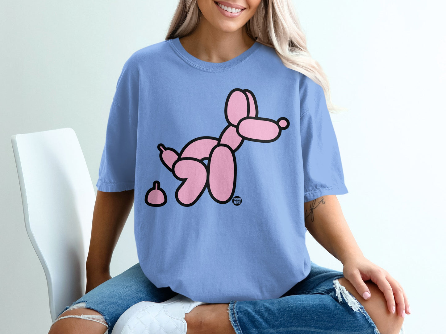Blue t-shirt with a pink balloon dog and a small pink shape.