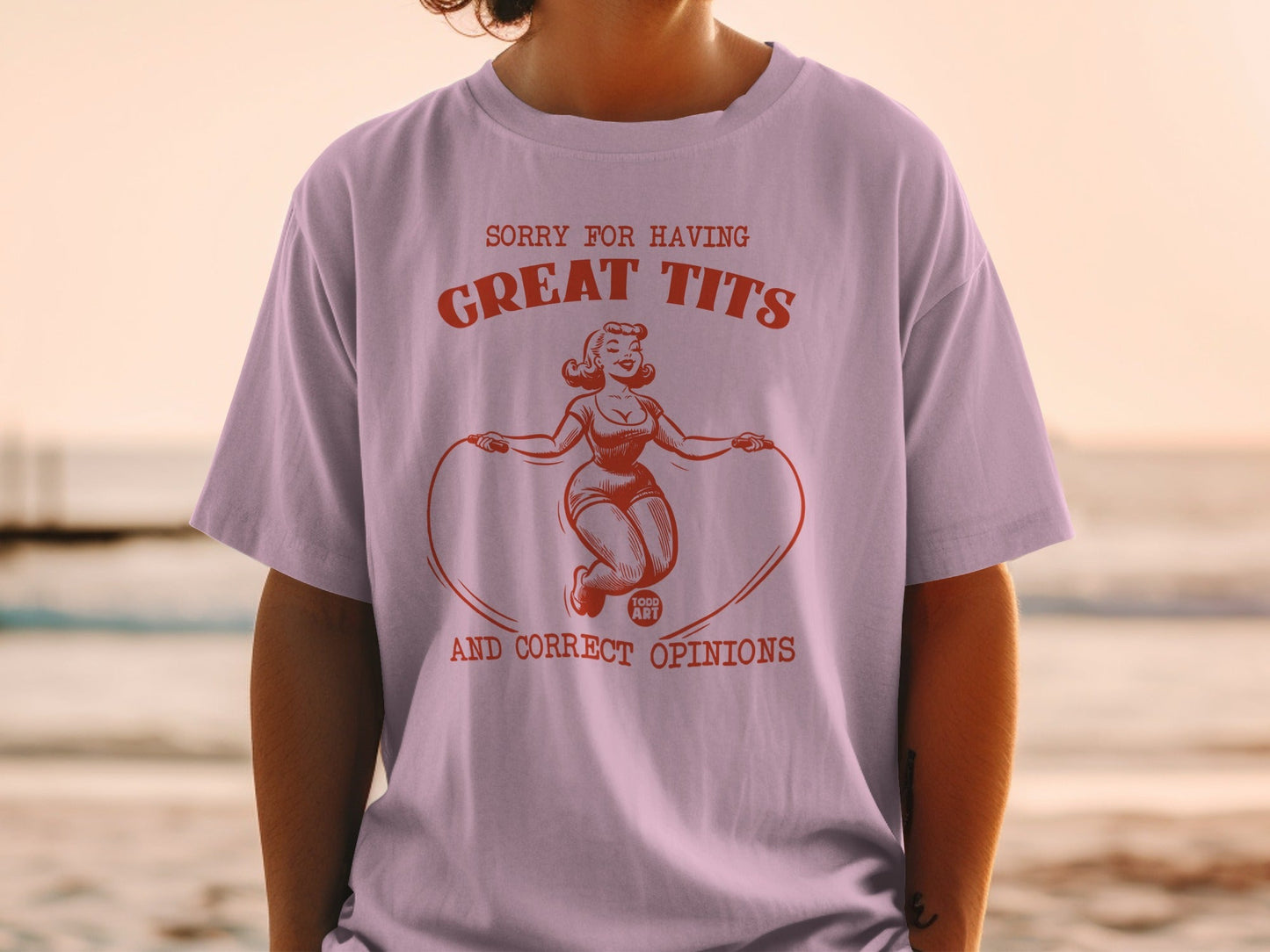 Pink t-shirt with retro illustration and text: "Sorry for having great tits and correct opinions."
