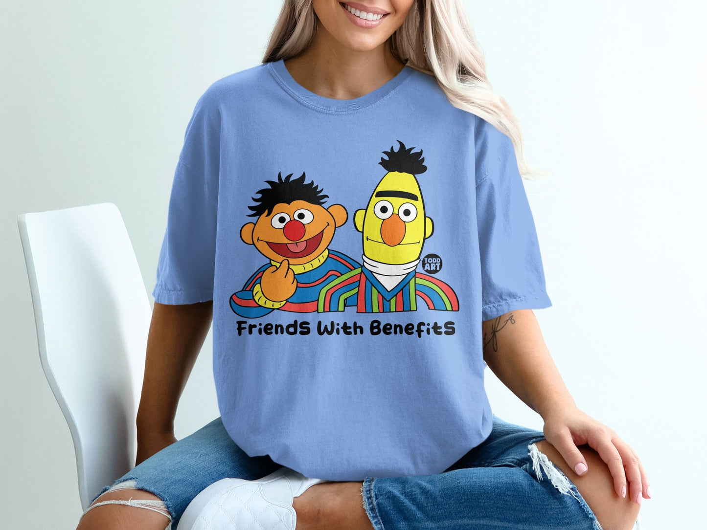 Bert and Ernie from Sesame Street on a light blue t-shirt.