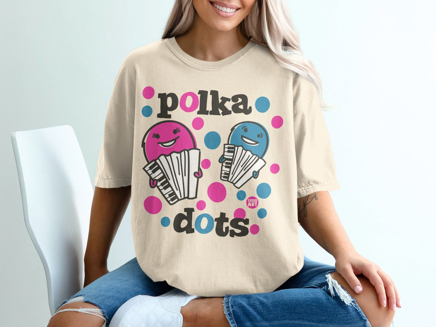 Cream t-shirt with cartoon accordions and "polka dots" text.