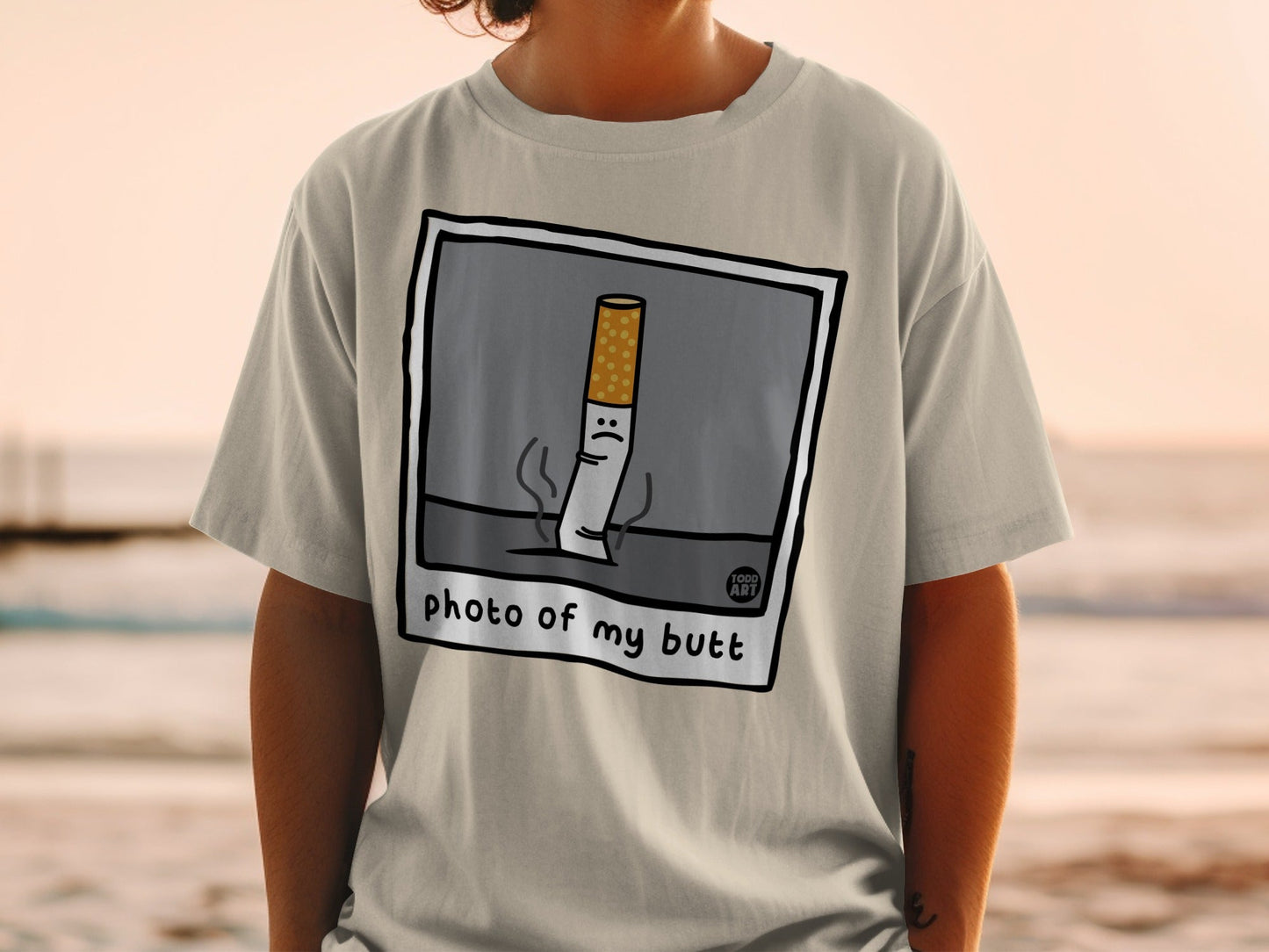 T-shirt with cartoon cigarette illustration and "photo of my butt" text.