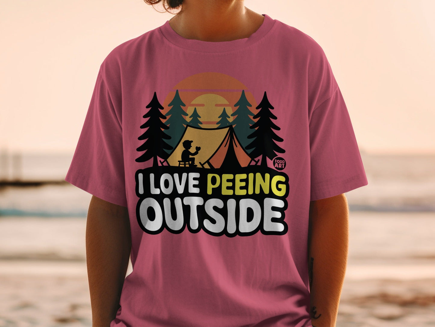 Pink t-shirt with "I Love Peeing Outside" text and camping graphic.