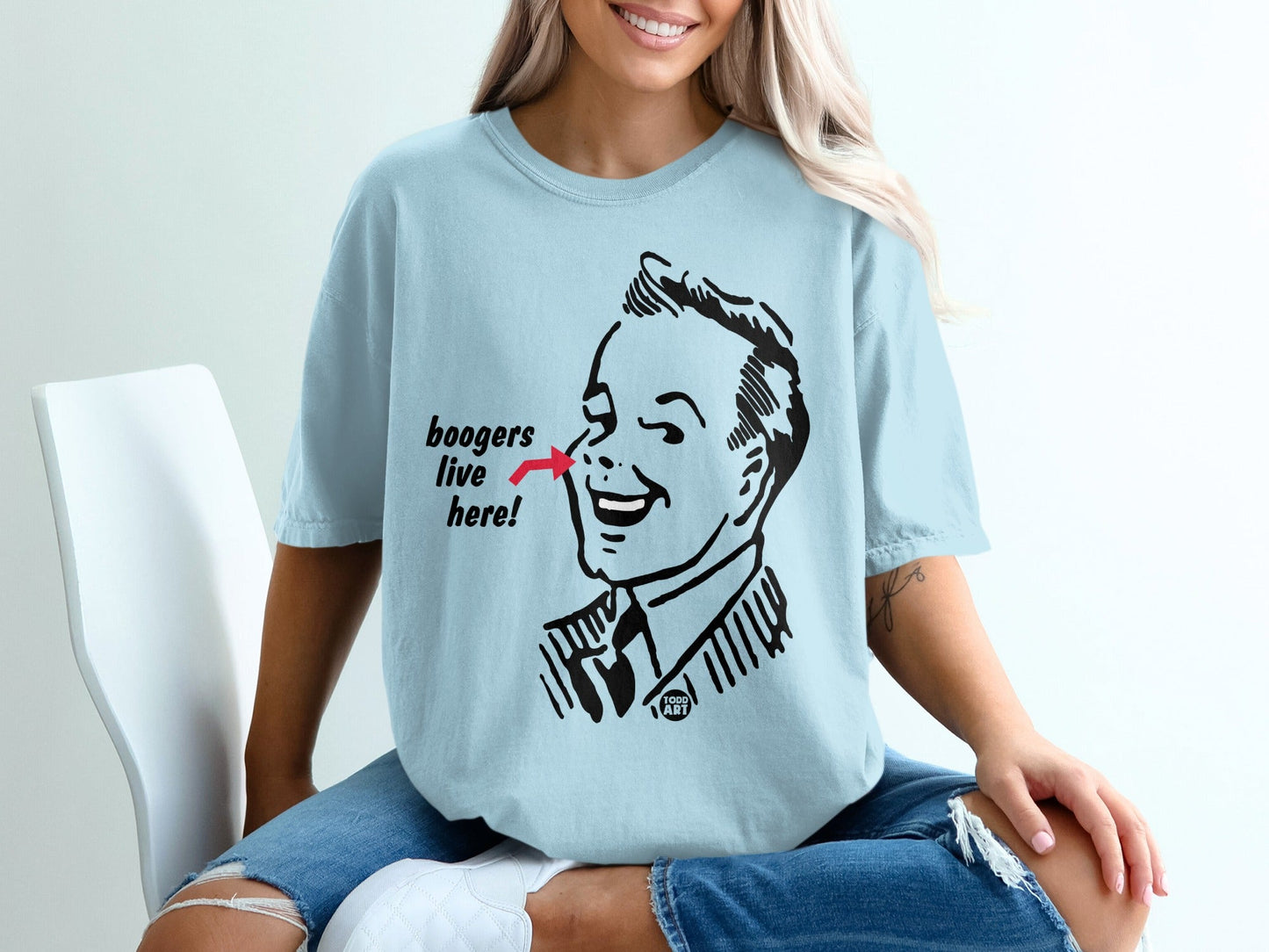 Light blue t-shirt with cartoon man pointing to nose, "boogers live here" text.