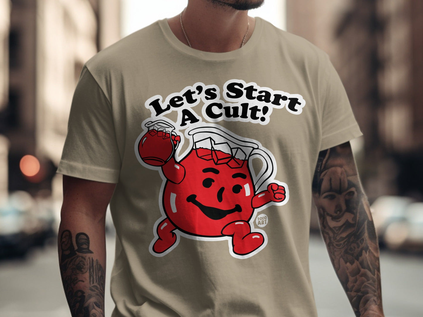 Kool-Aid Man character on tan t-shirt with text "Let's Start A Cult!"