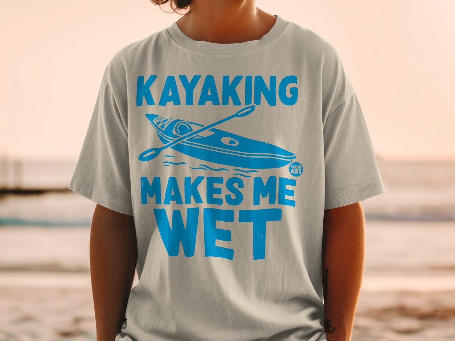Light blue t-shirt with "Kayaking Makes Me Wet" and kayak graphic.