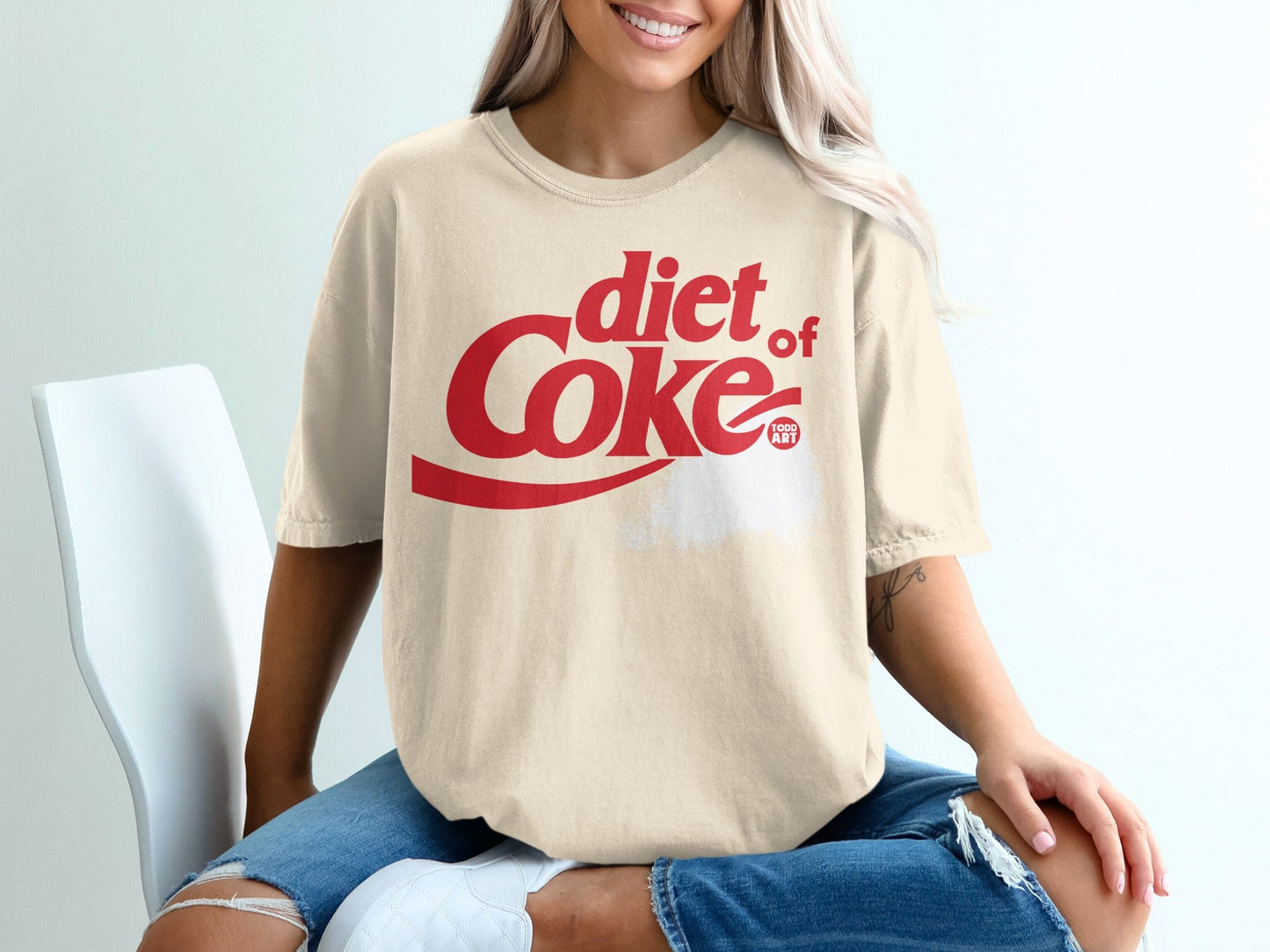 Cream t-shirt with red Diet Coke logo and "2022 ART" text.