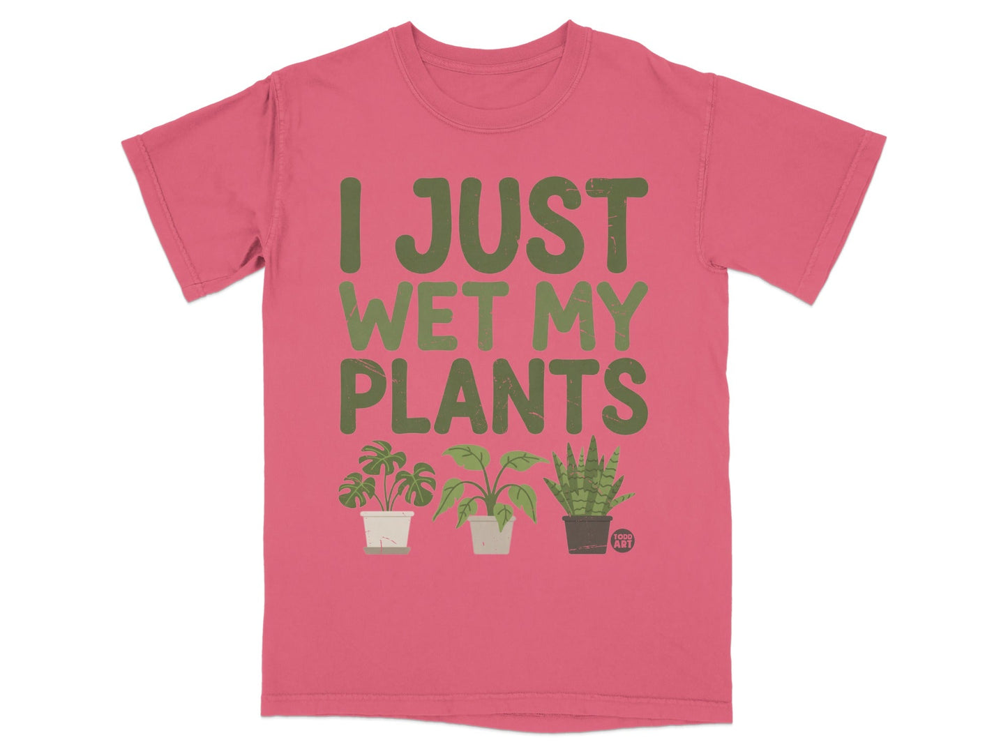 Pink t-shirt with green text "I JUST WET MY PLANTS" and three small potted plants.