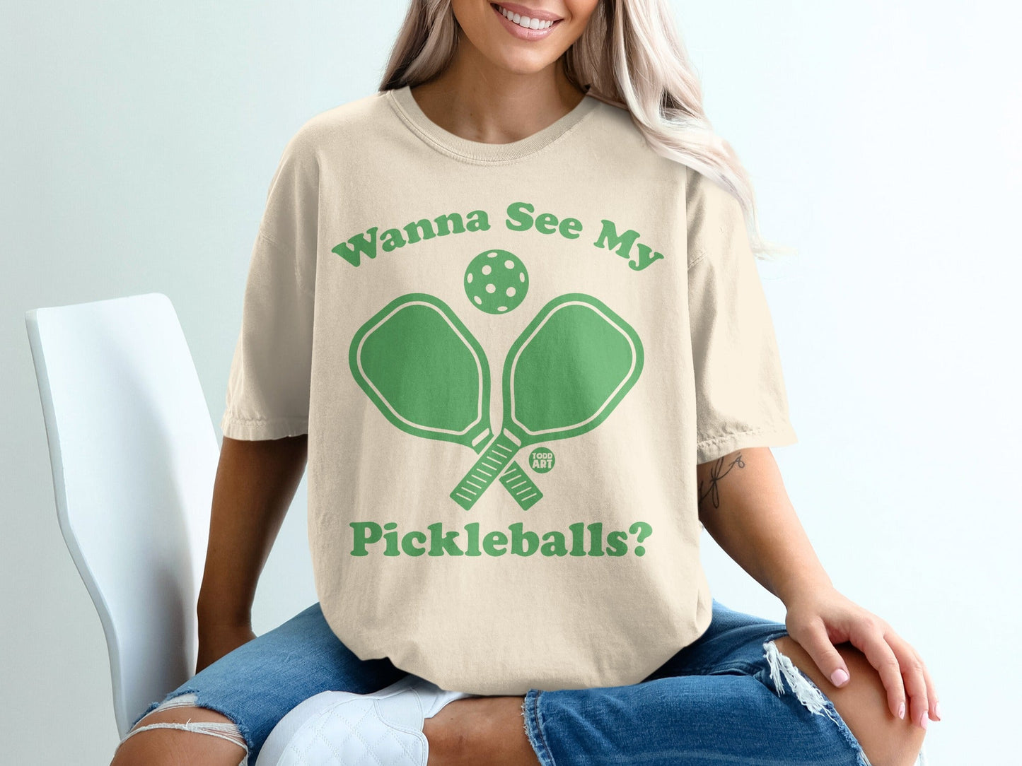 Cream t-shirt with green pickleball paddles and text "Wanna See My Pickleballs?".