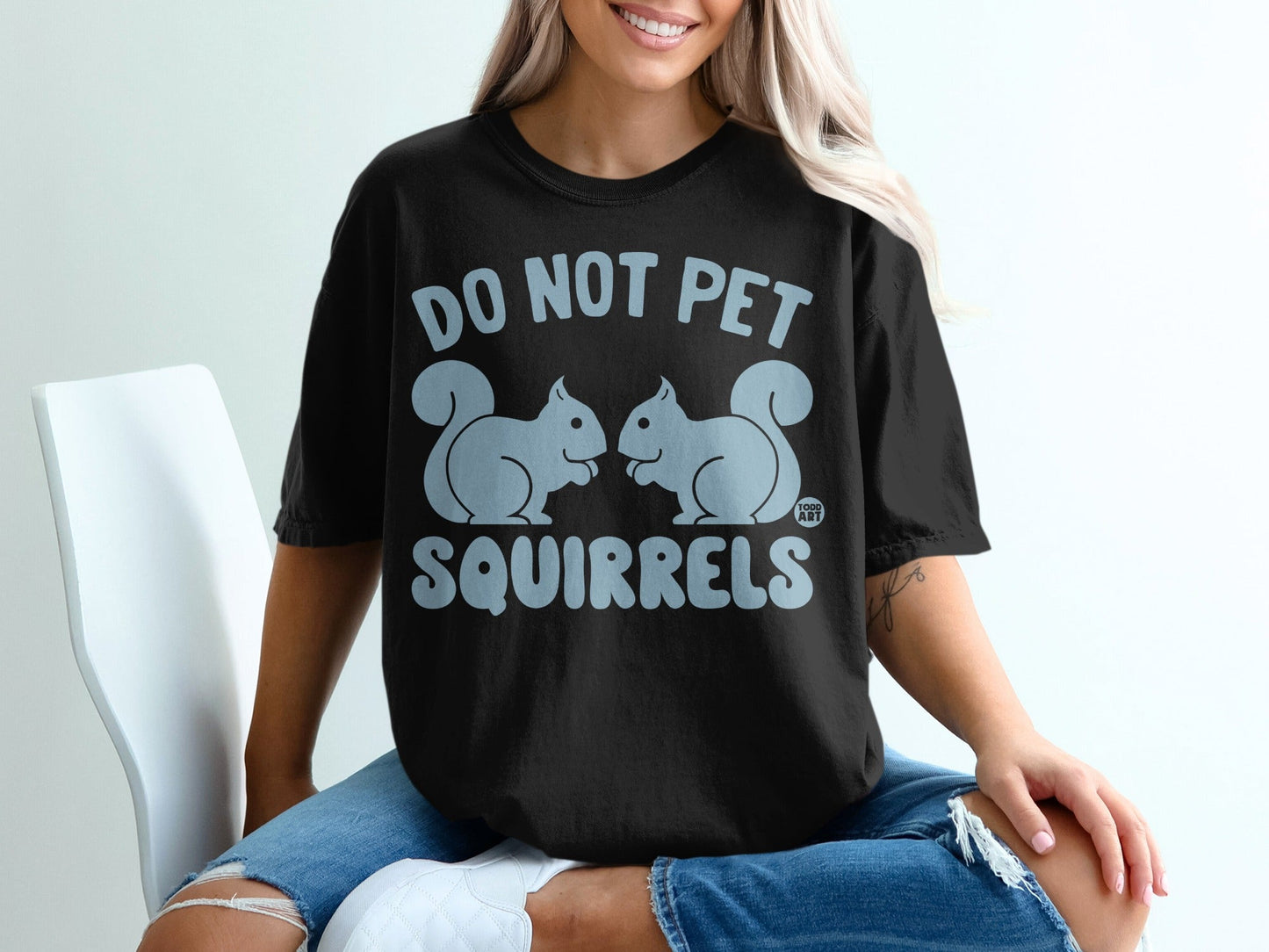 Black t-shirt with "DO NOT PET SQUIRRELS" and two cartoon squirrels.