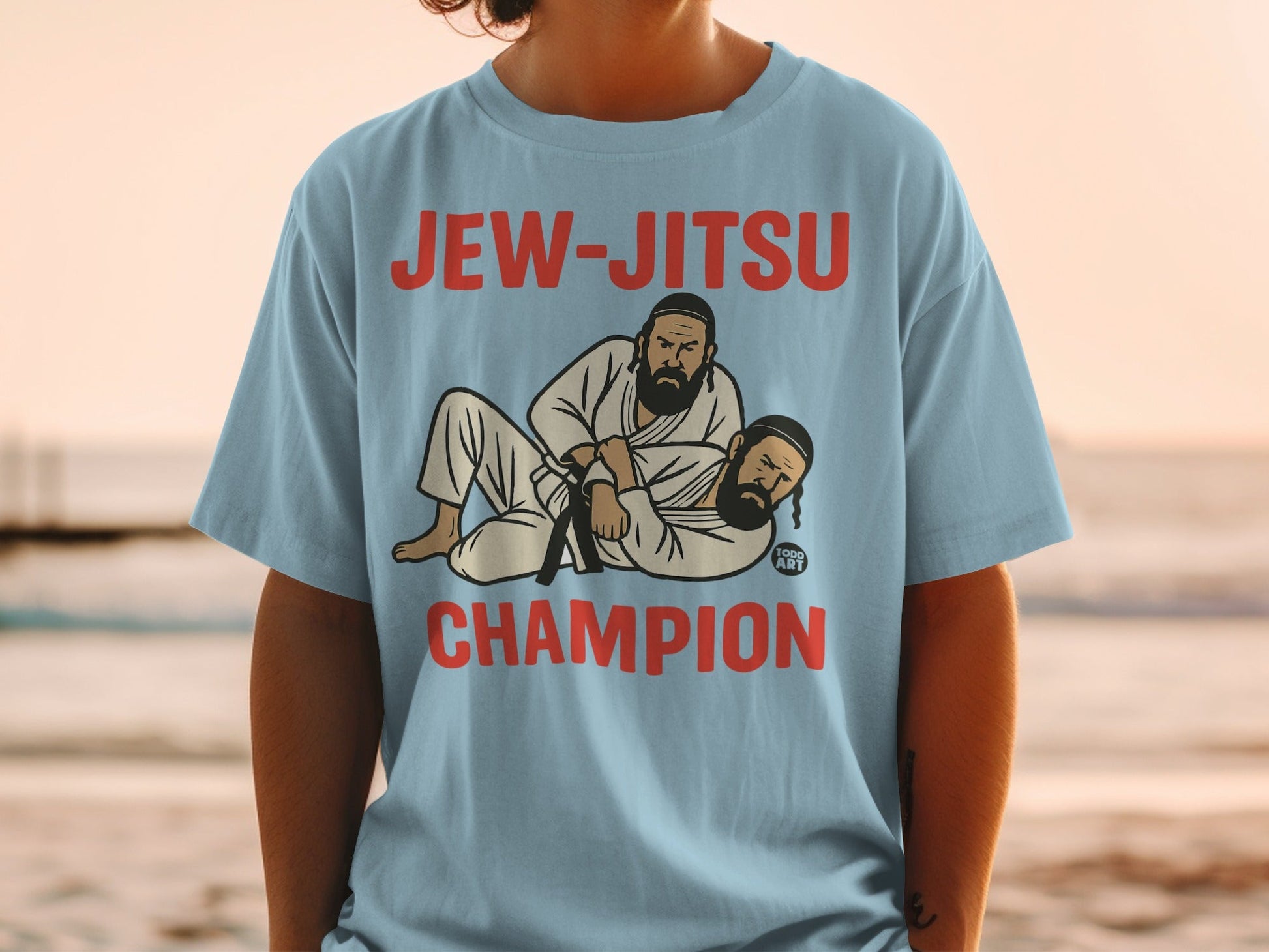 Light blue t-shirt featuring "JEW-JITSU CHAMPION" and illustrated fighters.