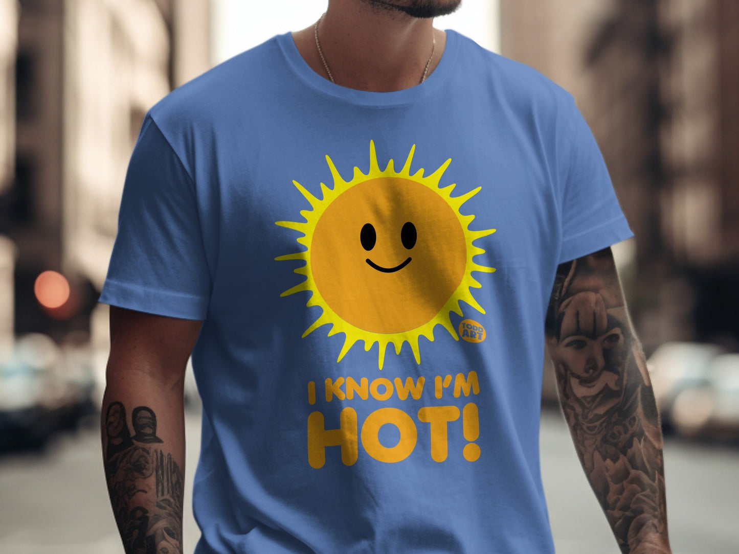 Blue t-shirt with a smiling sun graphic and text that reads "I KNOW I'M HOT!".